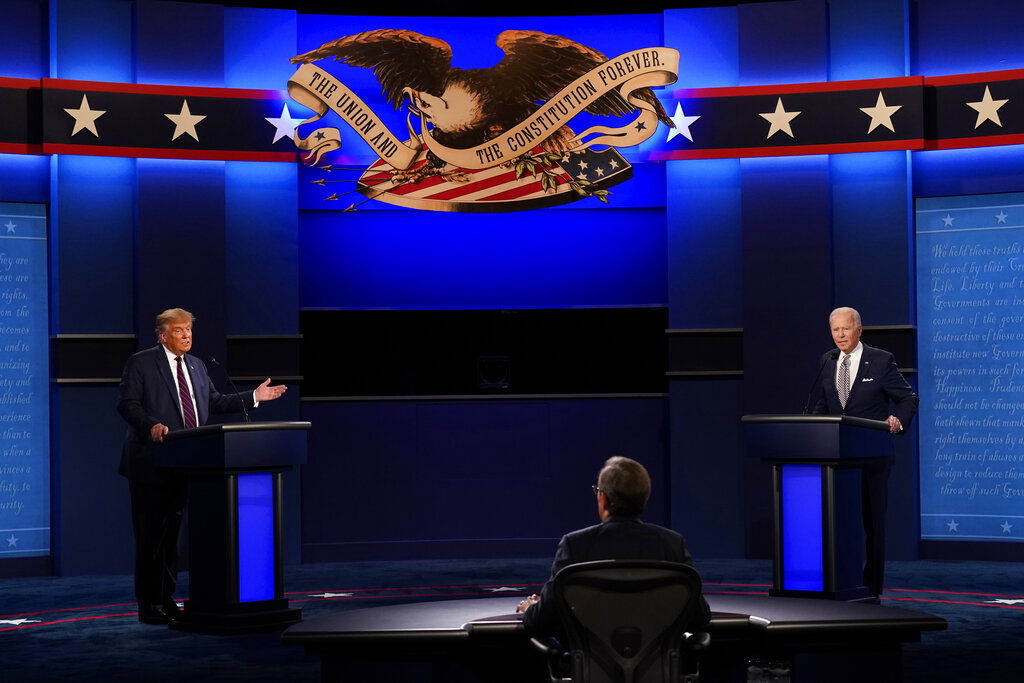 Moderator Chris Wallace of Fox News listens as President Donald Trump and Democratic candidate former Vice President Joe Biden participate in the first presidential debate Tuesday, Sept. 29, 2020, at Case Western University and Cleveland Clinic, in Cleveland, Ohio. (AP Photo/Patrick Semansky)