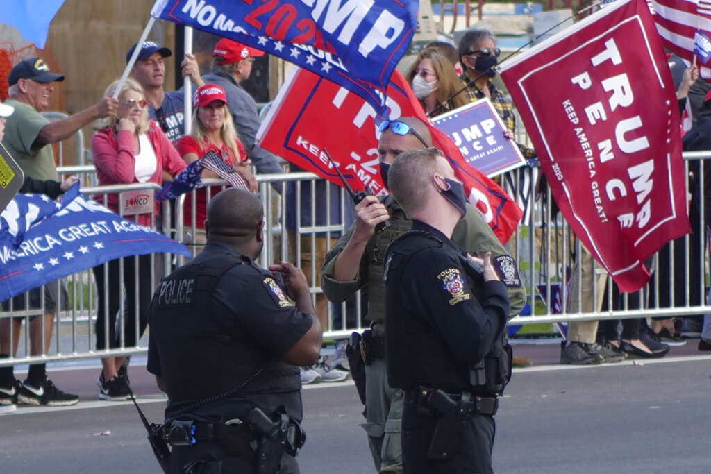 President Donald Turmp supporters gather outside Walter Reed National Military Medical Center in Bethesda, Md., Sunday, Oct. 4, 2020. Trump was admitted to the hospital after contracting COVID-19. (AP Photo/Anthony Peltier)