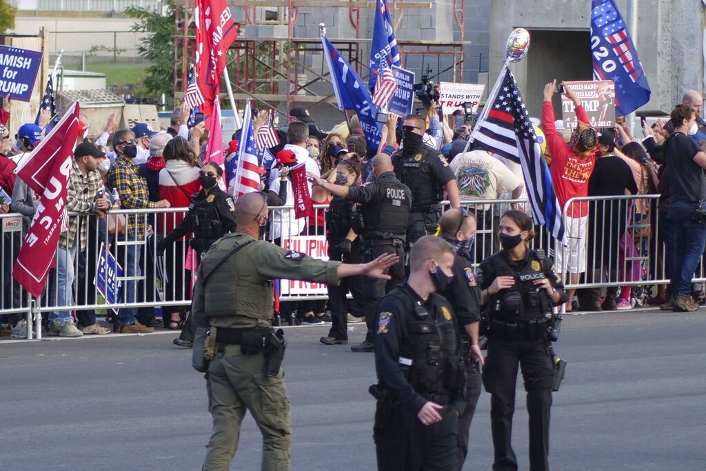 President Donald Trump supporters gather outside Walter Reed National Military Medical Center in Bethesda, Md., Sunday, Oct. 4, 2020. Trump was admitted to the hospital after contracting COVID-19. (AP Photo/Anthony Peltier)