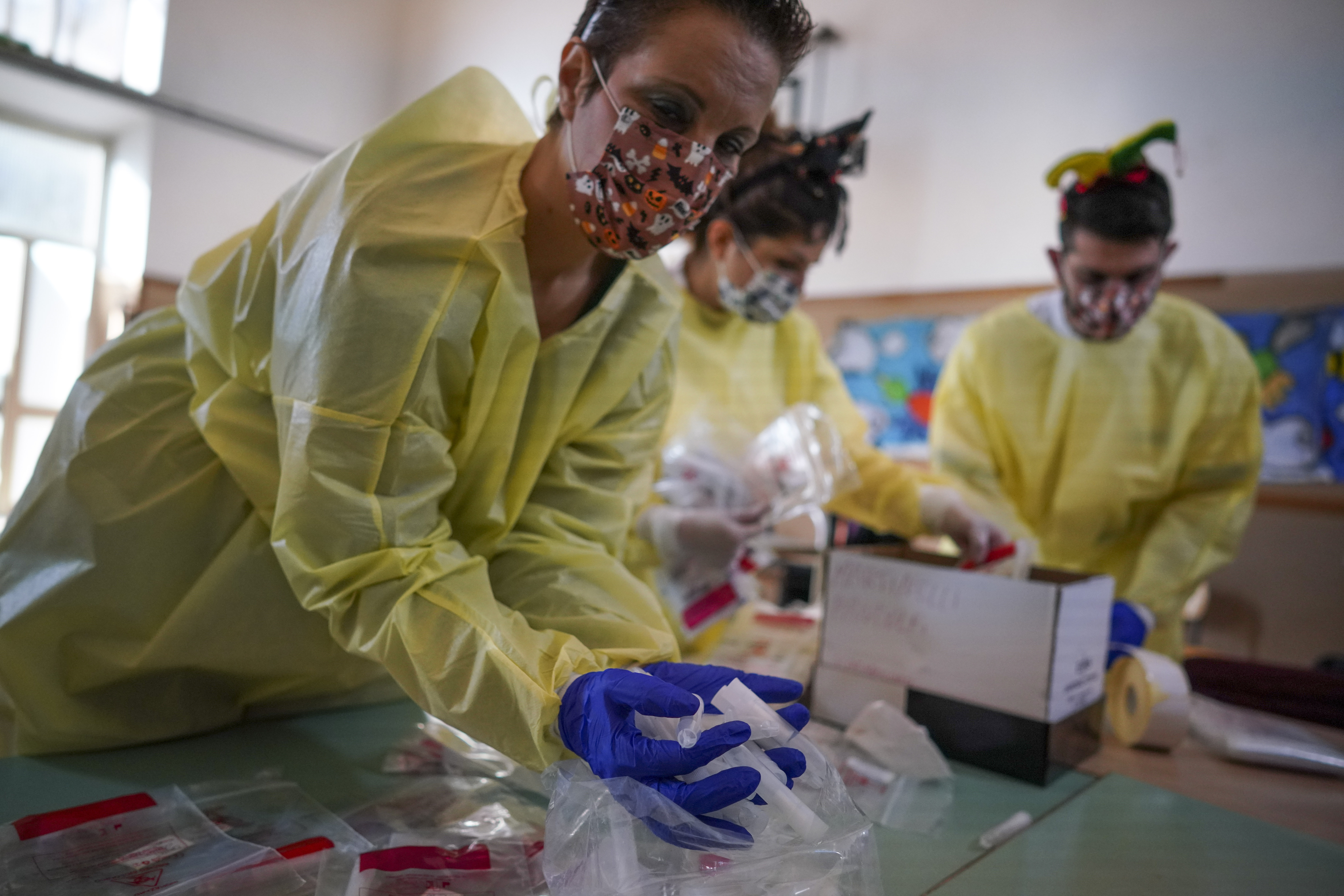 Medical personnel prepare non-invasive Covid 19 test with chewing gums at the G.B. Grassi school, in Fiumicino, near Rome, Tuesday, Oct. 6, 2020. (AP Photo/Andrew Medichini)