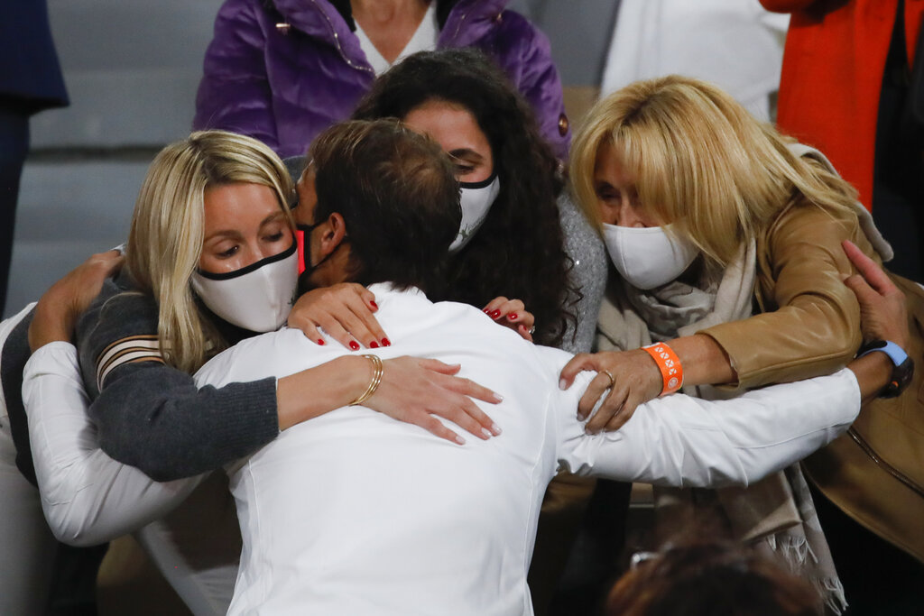 Spain's Rafael Nadal kisses his wife, left, and family members as he celebrates winning the final match of the French Open tennis tournament against Serbia's Novak Djokovic in three sets, 6-0, 6-2, 7-5, at the Roland Garros stadium in Paris, France, Sunday, Oct. 11, 2020. (AP Photo/Christophe Ena)