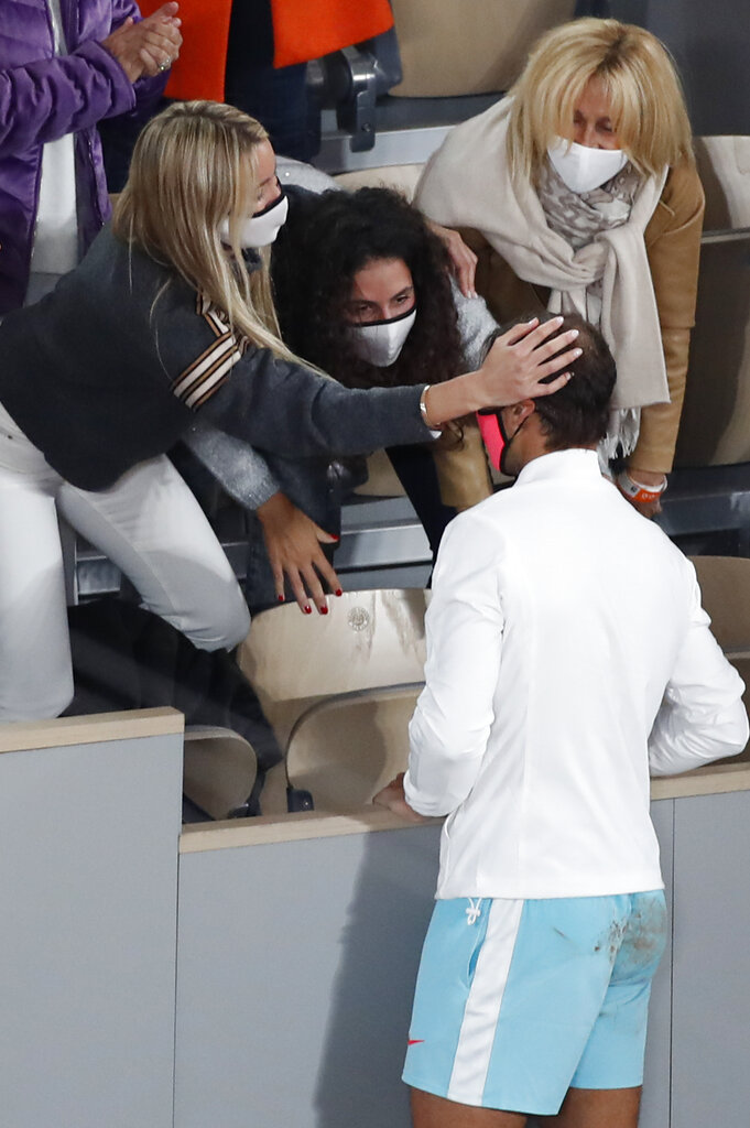 Spain's Rafael Nadal's wife, left, touches his head as he celebrates with family members winning the final match of the French Open tennis tournament against Serbia's Novak Djokovic in three sets, 6-0, 6-2, 7-5, at the Roland Garros stadium in Paris, France, Sunday, Oct. 11, 2020. (AP Photo/Alessandra Tarantino)