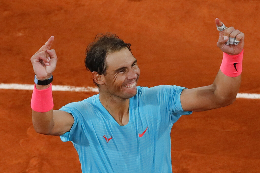 Spain's Rafael Nadal celebrates winning the final match of the French Open tennis tournament against Serbia's Novak Djokovic in three sets, 6-0, 6-2, 7-5, at the Roland Garros stadium in Paris, France, Sunday, Oct. 11, 2020. (AP Photo/Christophe Ena)