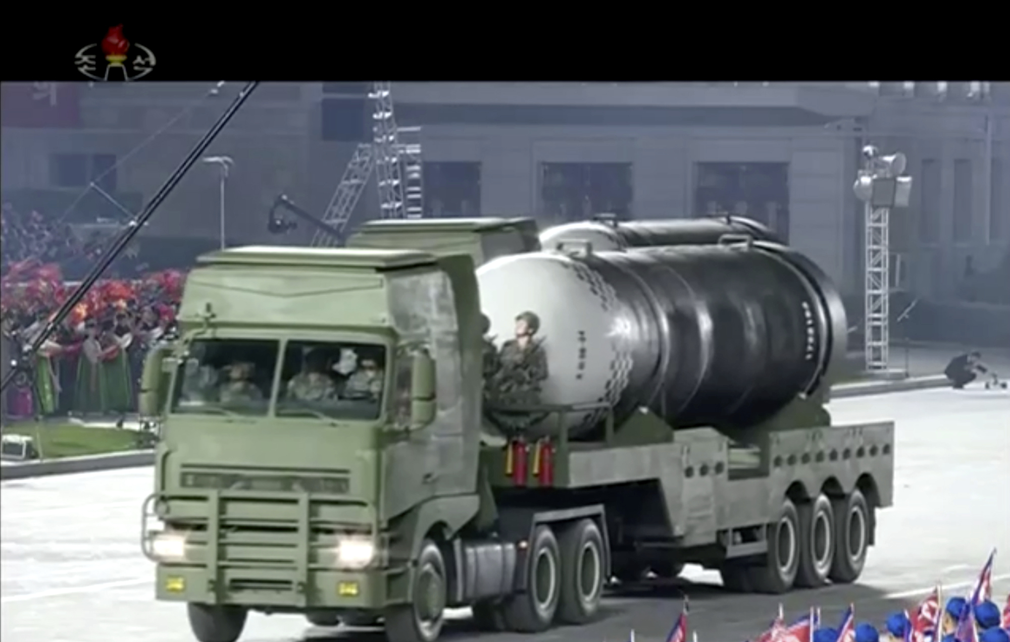 This image made from video broadcasted by North Korea's KRT, shows a military parade with what appears to be a possible new solid-fuel missile at the Kim Il Sung Square in Pyongyang, Saturday, Oct. 10, 2020. North Korean leader Kim Jong Un warned Saturday that his country would “fully mobilize” its nuclear force if threatened as he took center stage at a massive military parade to mark the 75th anniversary of the country’s ruling party. (KRT via AP)