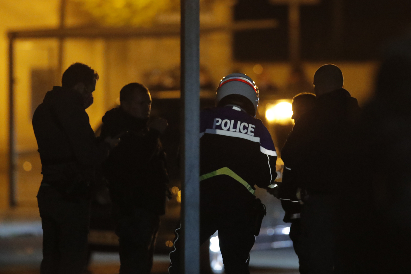 French police officers gather outside a high school after a history teacher who opened a discussion with students on caricatures of Islam's Prophet Muhammad was beheaded, Friday, Oct. 16, 2020 in Conflans-Saint-Honorine, north of Paris. Police have shot the suspected killer dead. (AP Photo/Michel Euler)