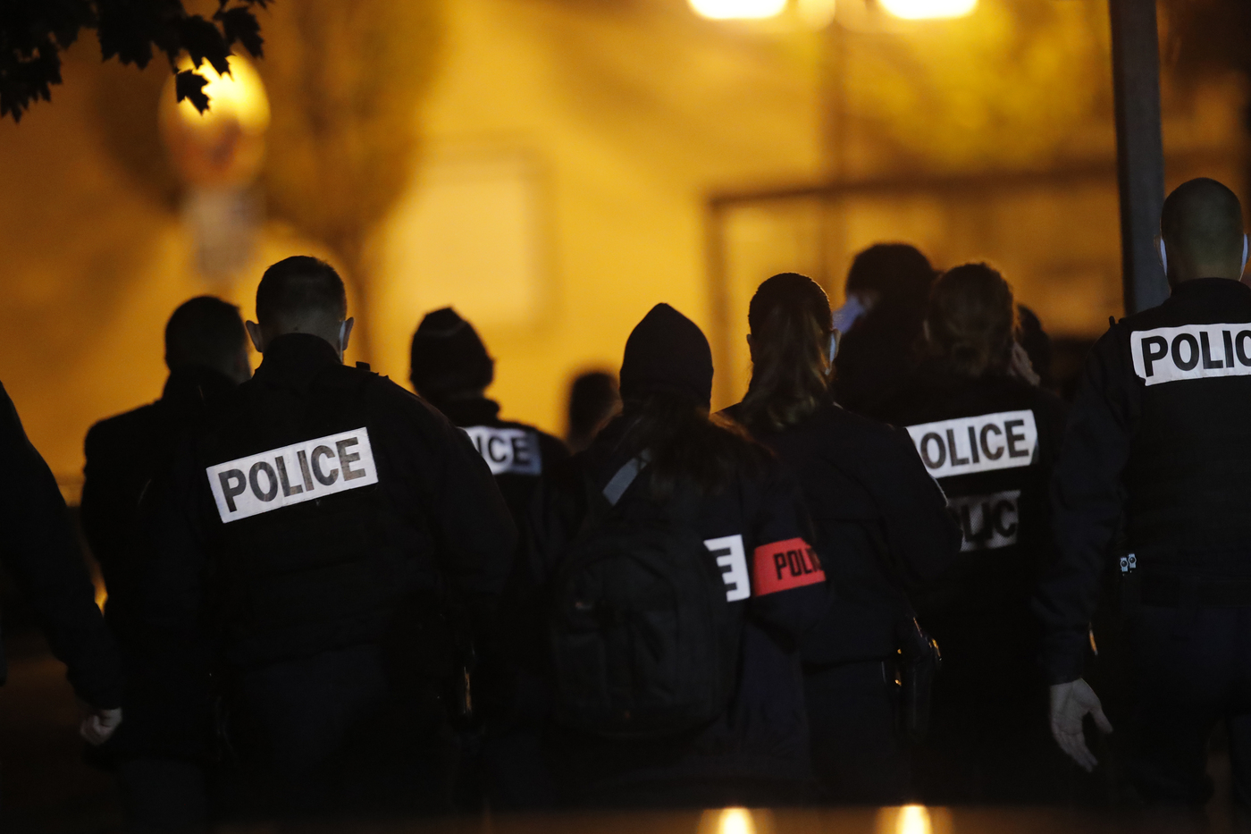 French police officers gather outside a high school after a history teacher who opened a discussion with students on caricatures of Islam's Prophet Muhammad was beheaded, Friday, Oct. 16, 2020 in Conflans-Saint-Honorine, north of Paris. Police have shot the suspected killer dead. (AP Photo/Michel Euler)