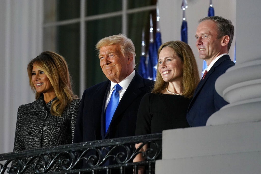 From left, first lady Melania Trump, President Donald Trump, Amy Coney Barrett and Jesse Barrett, stand on the Blue Room Balcony after Supreme Court Justice Clarence Thomas administered the Constitutional Oath on the South Lawn of the White House in Washington, Monday, Oct. 26, 2020. (AP Photo/Patrick Semansky)