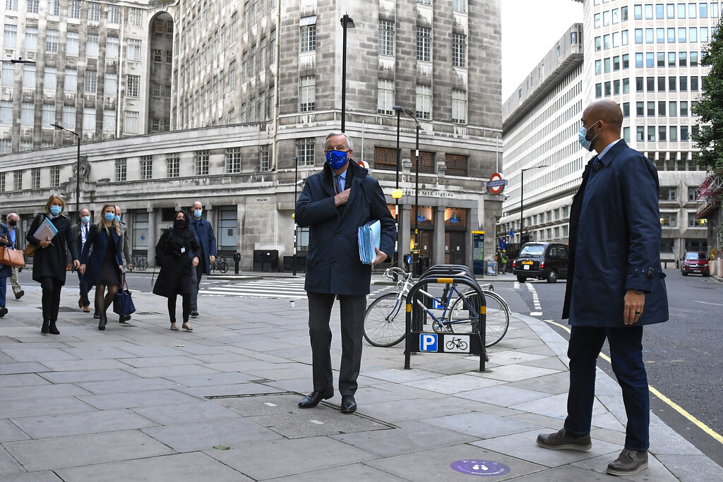 EU Chief Negotiator Michel Barnier wears an EU-themed face mask as he makes his way to the Westminster Conference Centre in London, Saturday, Oct. 24, 2020.(AP Photo/Alberto Pezzali)