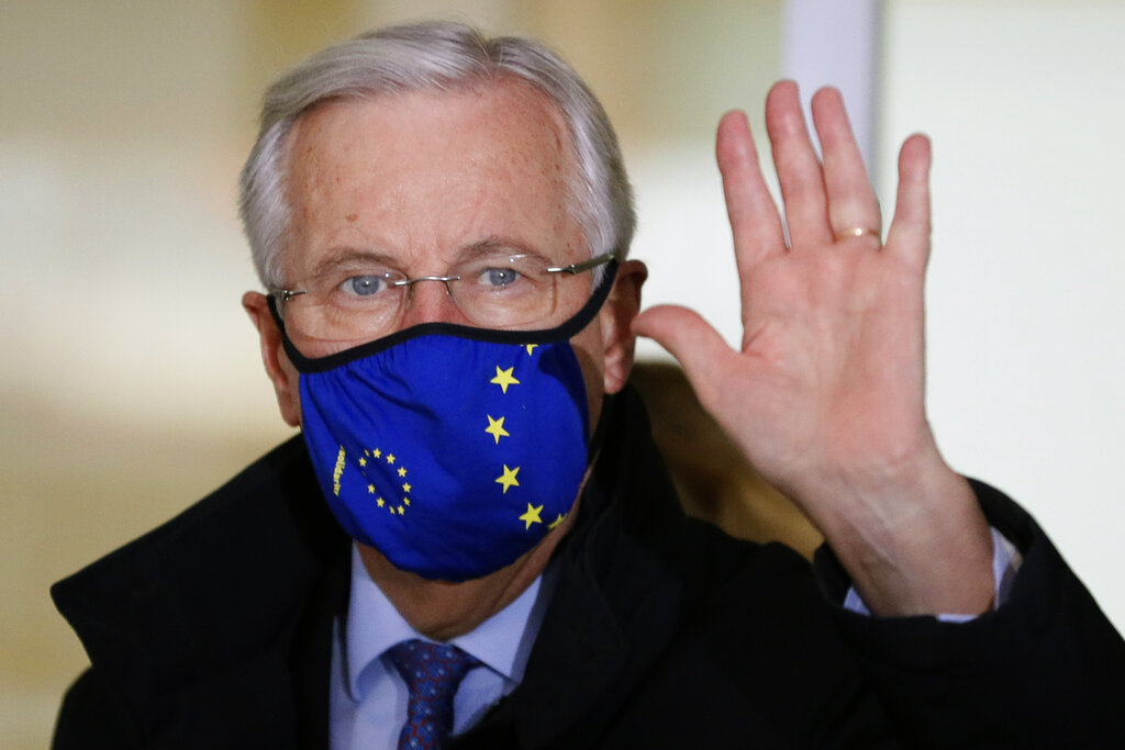 EU Chief negotiator Michel Barnier waves as he leaves his hotel to walk to a meeting in London, Friday, Oct. 23, 2020. Barnier is in London to resume talks over post Brexit trade agreements. (AP Photo/Kirsty Wigglesworth)