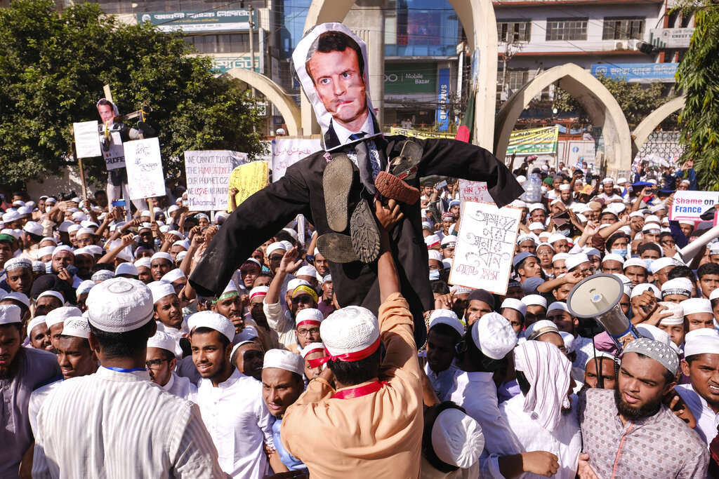 Supporters of Islamist parties carry an effigy of French President Emmanuel Macron during a protest after Friday prayers in Dhaka, Bangladesh, Friday, Oct. 30, 2020. Thousands of Muslims and activists marched through streets and rallied across Bangladesh’s capital on Friday against the French president’s support of secular laws that deem caricatures of the Prophet Muhammad as protected under freedom of speech. (AP Photo/Mahmud Hossain Opu)