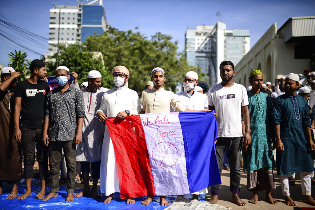 Supporters of several Islamist parties protest after Friday prayers in Dhaka, Bangladesh, Friday, Oct. 30, 2020. Thousands of Muslims and activists marched through streets and rallied across Bangladesh’s capital on Friday against the French president’s support of secular laws that deem caricatures of the Prophet Muhammad as protected under freedom of speech. (AP Photo/Mahmud Hossain Opu)