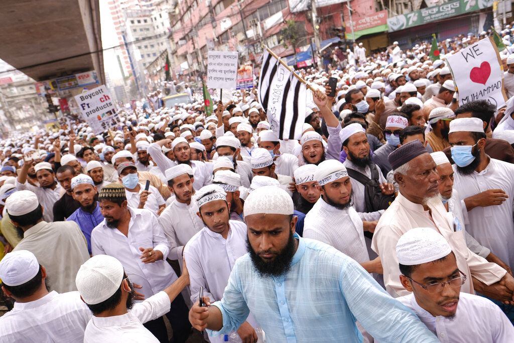 Thousands of Bangladeshi Muslims protesting the French president’s support of secular laws allowing caricatures of the Prophet Muhammad march to lay siege on the French Embassy in Dhaka, Bangladesh, Monday, Nov.2, 2020. (AP Photo/Mahmud Hossain Opu)