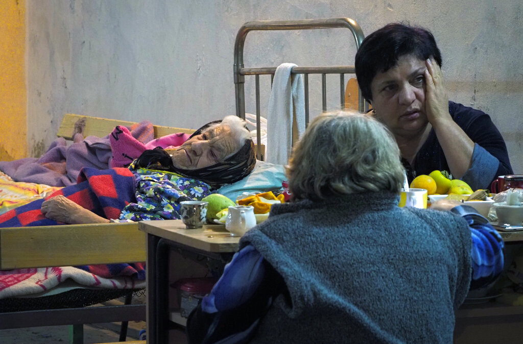 Women take refuge in a bomb shelter in Stepanakert, the separatist region of Nagorno-Karabakh, Tuesday, Nov. 3, 2020. Fighting over the separatist territory of Nagorno-Karabakh entered sixth week on Sunday, with Armenian and Azerbaijani forces blaming each other for new attacks. (AP Photo)