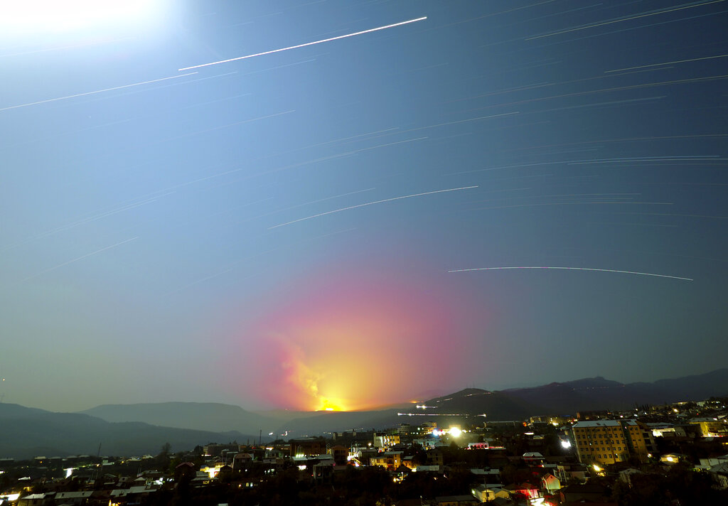 In this photo taken with long time exposure explosions are seen in the mountains during fighting between Armenian and Azerbaijan's forces during a military conflict outside Stepanakert, the separatist region of Nagorno-Karabakh, Sunday, Nov. 1, 2020. Fighting over the separatist territory of Nagorno-Karabakh entered sixth week on Sunday, with Armenian and Azerbaijani forces blaming each other for new attacks. (AP Photo)