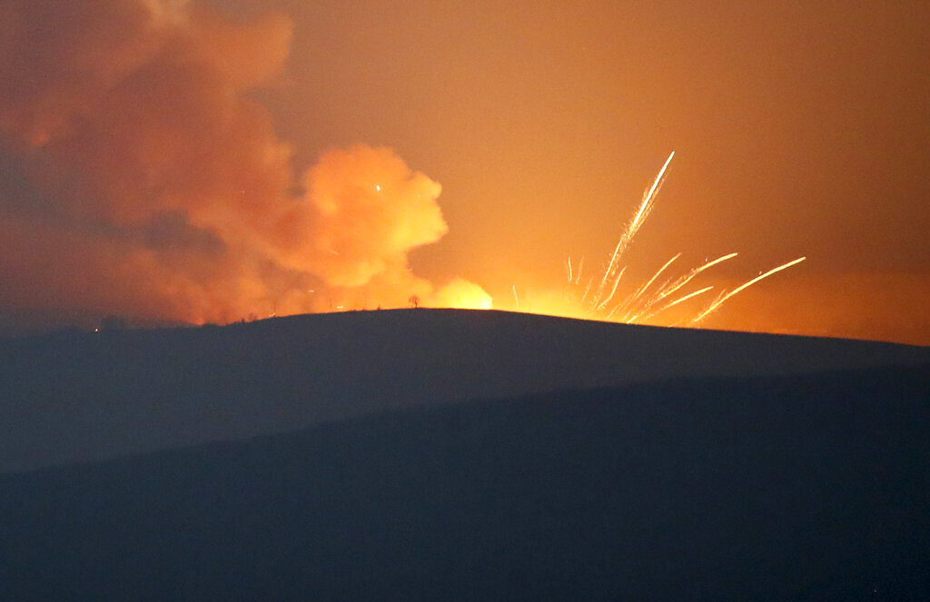 Explosions are seen in the mountains during fighting between Armenian and Azerbaijan's forces during a military conflict outside Stepanakert, the separatist region of Nagorno-Karabakh, Sunday, Nov. 1, 2020. Fighting over the separatist territory of Nagorno-Karabakh entered sixth week on Sunday, with Armenian and Azerbaijani forces blaming each other for new attacks. (AP Photo)