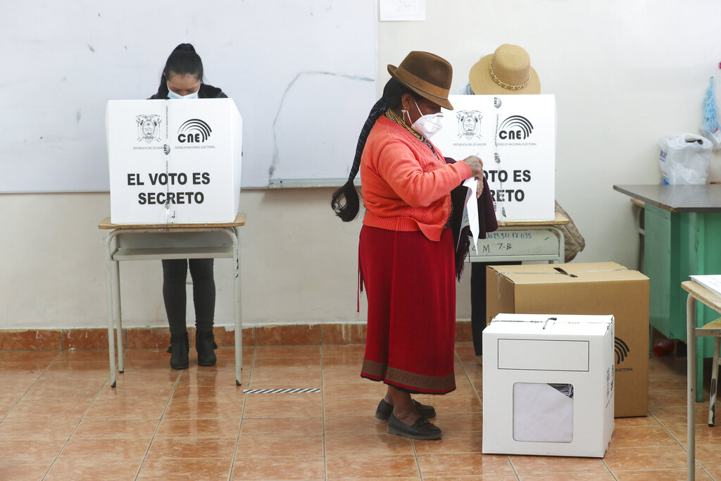 A woman votes during general elections in Cangahua, Ecuador, Sunday, Feb. 7, 2021. Amidst the new coronavirus pandemic Ecuadoreans went to the polls in a first round presidential and legislative election. (AP Photo/Dolores Ochoa)