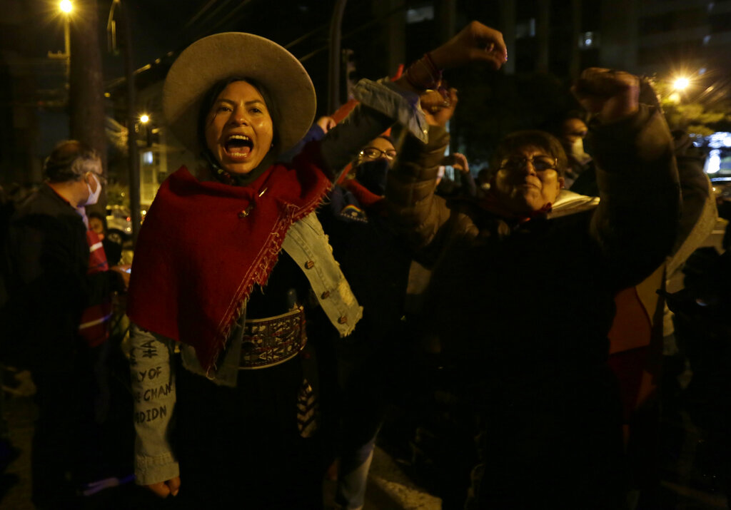 Supporters of Yaku Perez, presidential candidate representing the Indigenous party Pachakutik, cheer with Perez outside the Swiss Hotel where international electoral observers are staying, after the closing of the polls during general elections in Quito, Ecuador, Sunday, Feb. 7, 2021. (AP Photo/Dolores Ochoa)