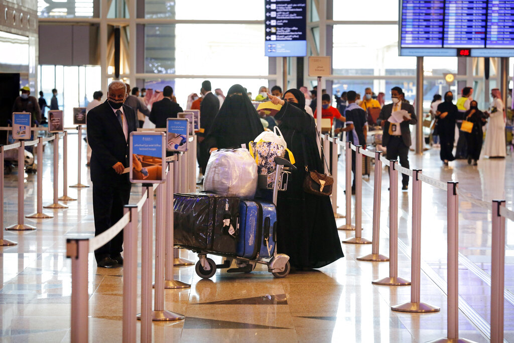 Saudi passengers enter King Abdulaziz International Airport in Jiddah, Saudi Arabia, Monday, May 17, 2021. Vaccinated Saudis will be allowed to leave the kingdom for the first time in more than a year as the country eases a ban on international travel that had been in place to try and contain the spread of the coronavirus and its new variants. (AP Photo/Amr Nabil)