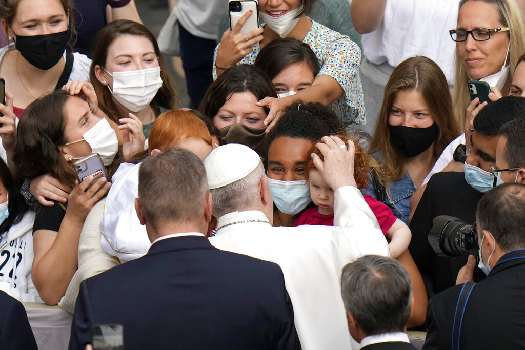 Pope Francis caresses a child as he arrives for his weekly general audience, at the Vatican, Wednesday, June 9, 2021. (AP Photo/Alessandra Tarantino)