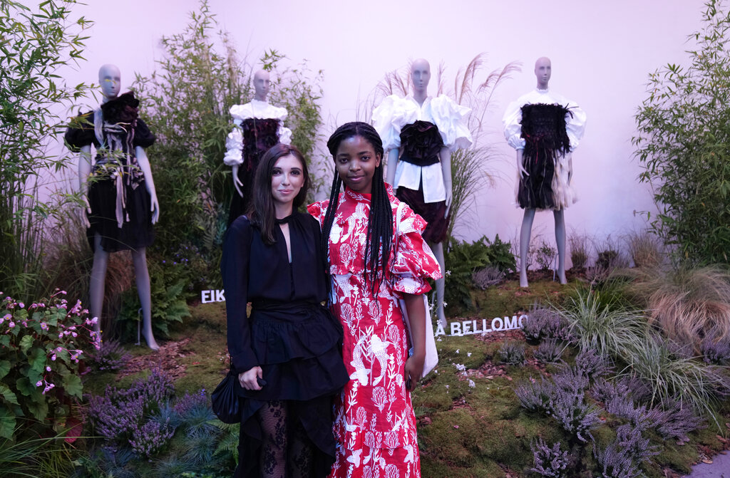 Fashion designers Ilaria Bellomo, left and Fikile Sokhulu pose in front of their creations of the Spring Summer 2022 collection, unveiled during the Milan Fashion Week, in Milan, Italy, Tuesday, Sept. 21, 2021. (AP Photo/Antonio Calanni)