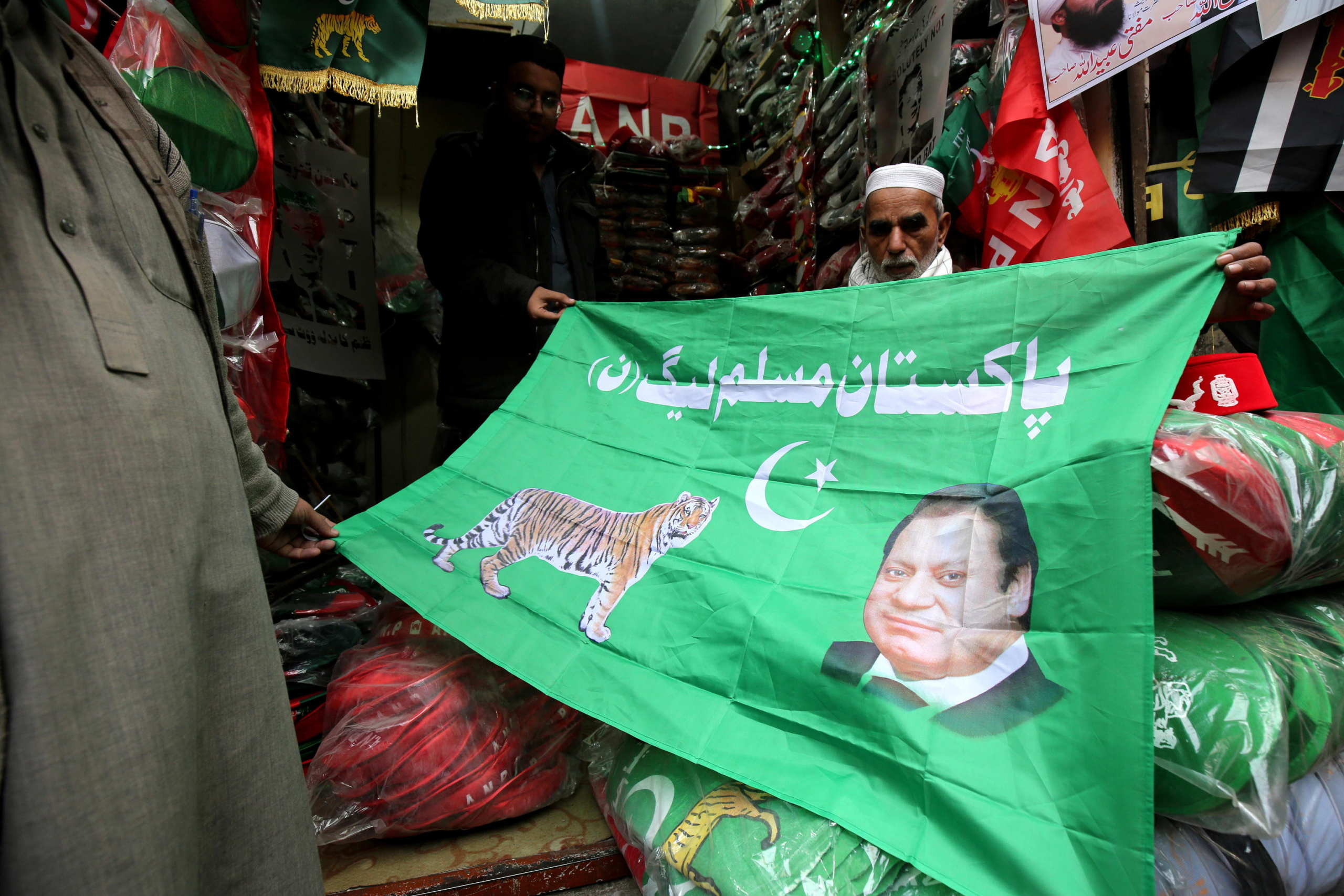 epa11067351 Vendors sell flags of Pakistan Muslim League Nawaz (PML-N) depicting images of the party's leader former Prime Minister Nawaz Sharif as the country gears up for general elections, in Peshawar, Pakistan, 10 January 2024. General elections are set to be held in Pakistan on 08 February 2024.  EPA/BILAWAL ARBAB