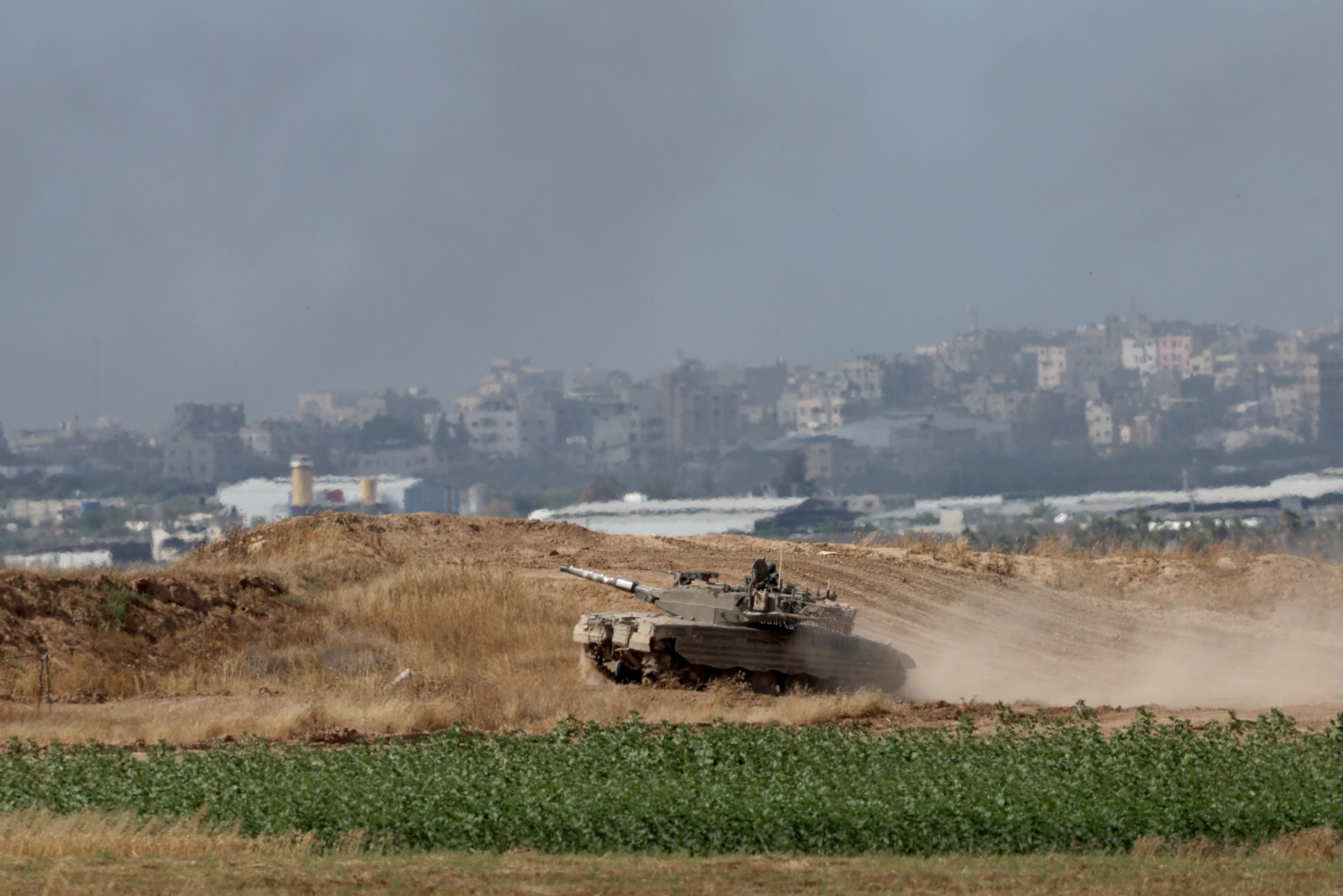 epa11337112 An Israeli tank maneuvers along the border with the Gaza Strip, near the Palestinian city of Jabalia, as seen from the Israeli side of the border, southern Israel, 13 May 2024. More than 34,900 Palestinians and over 1,455 Israelis have been killed, according to the Palestinian Health Ministry and the Israel Defense Forces (IDF), since Hamas militants launched an attack against Israel from the Gaza Strip on 07 October 2023, and the Israeli operations in Gaza and the West Bank which followed it.  EPA/ATEF SAFADI