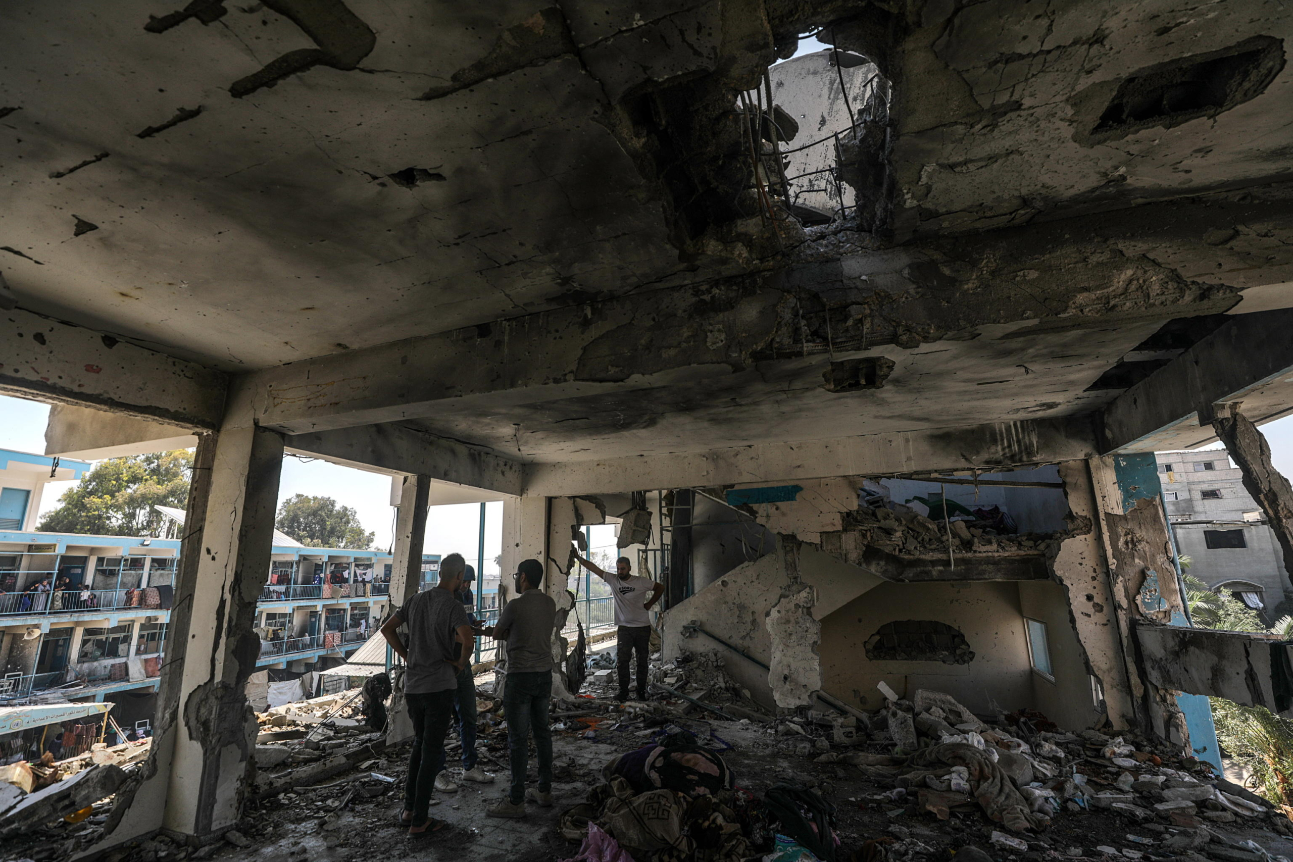 epa11392750 Palestinians inspect a destroyed UNRWA school following an Israeli air strike in Al Nusairat refugee camp in the central Gaza Strip, 06 June 2024. According to the Palestinian News Agency Wafa, at least 32 people  were killed and dozens others were injured on early 06 June following an Israeli strike on a UNRWA school sheltering displaced Palestinians, located in the Nuseirat refugee camp in the central Gaza strip. The Israeli army said that it had 