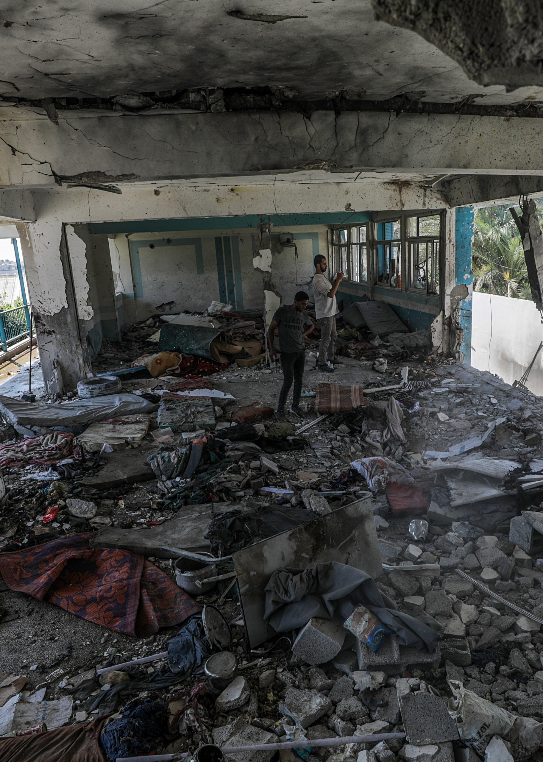 epa11392766 Palestinians inspect a destroyed UNRWA school following an Israeli air strike in Al Nusairat refugee camp in the central Gaza Strip, 06 June 2024. According to the Palestinian News Agency Wafa, at least 32 people  were killed and dozens others were injured on early 06 June following an Israeli strike on a UNRWA school sheltering displaced Palestinians, located in the Nuseirat refugee camp in the central Gaza strip. The Israeli army said that it had 