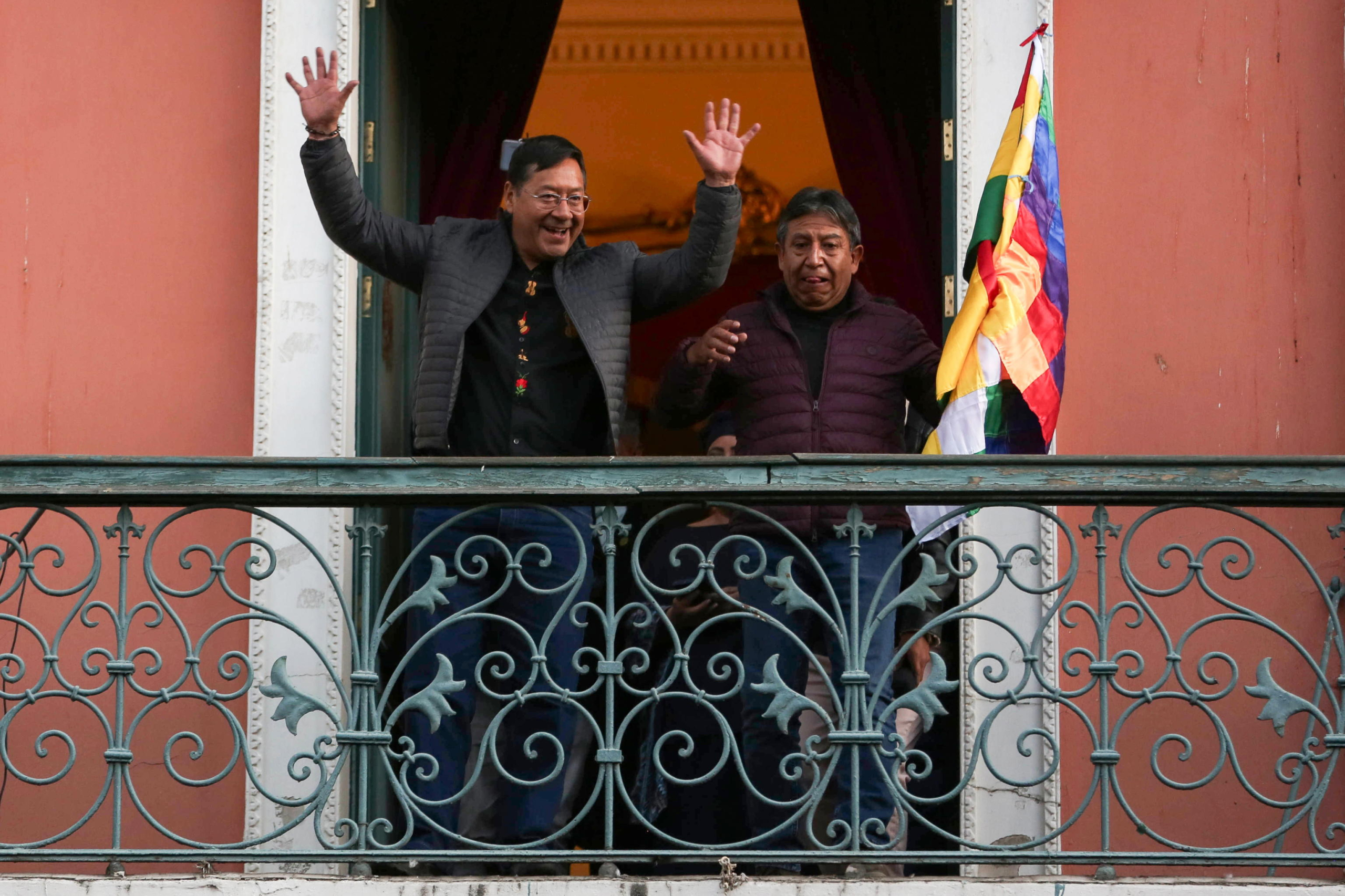 epa11440747 Bolivian President Luis Arce (L) and Vice President David Choquehuanca greet followers gathered at Plaza Murillo in La Paz, Bolivia, 26 June 2024.  A group of soldiers led by Bolivian Army general commander Juan Jose Zuniga entered Plaza Murillo on 26 June 2024 using a tank to knock down the door of the government headquarters. The soldiers withdrew after Bolivian President Luis Arce changed the heads of the entire military high command, describing the action as a coup attempt.  EPA/Luis Gandarillas