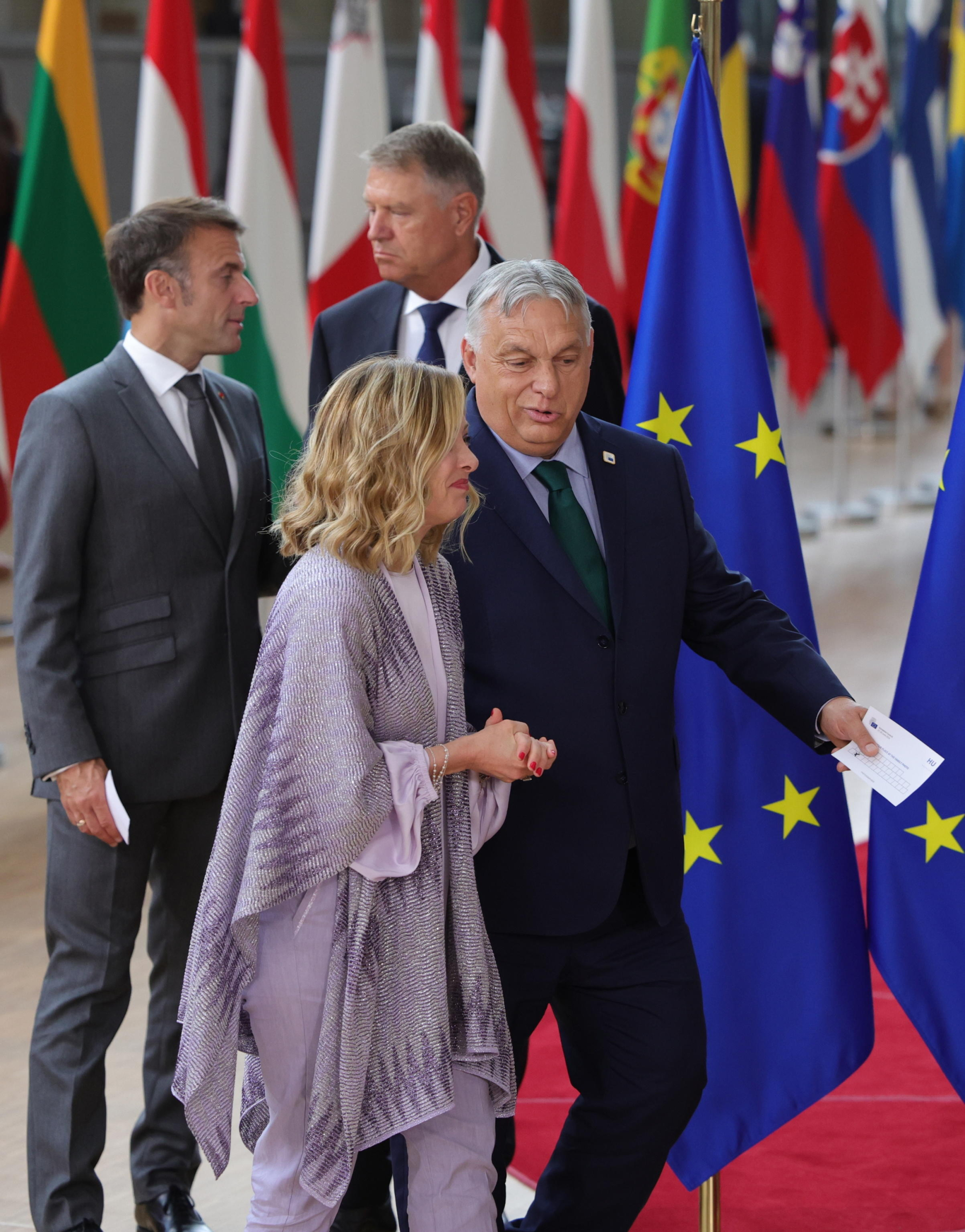 epa11441396 (L-R) France's President Emmanuel Macron, Romania's President Klaus Iohannis, Italy's Prime Minister Giorgia Meloni and Hungary's Prime Minister Viktor Orban arrive for a family photo during a European Council in Brussels, Belgium, 27 June 2024. EU leaders are gathering in Brussels for a two-day summit to discuss the Strategic Agenda 2024-2029, the next institutional cycle, Ukraine, the Middle East, competitiveness, security and defense, among other topics.  EPA/OLIVIER MATTHYS