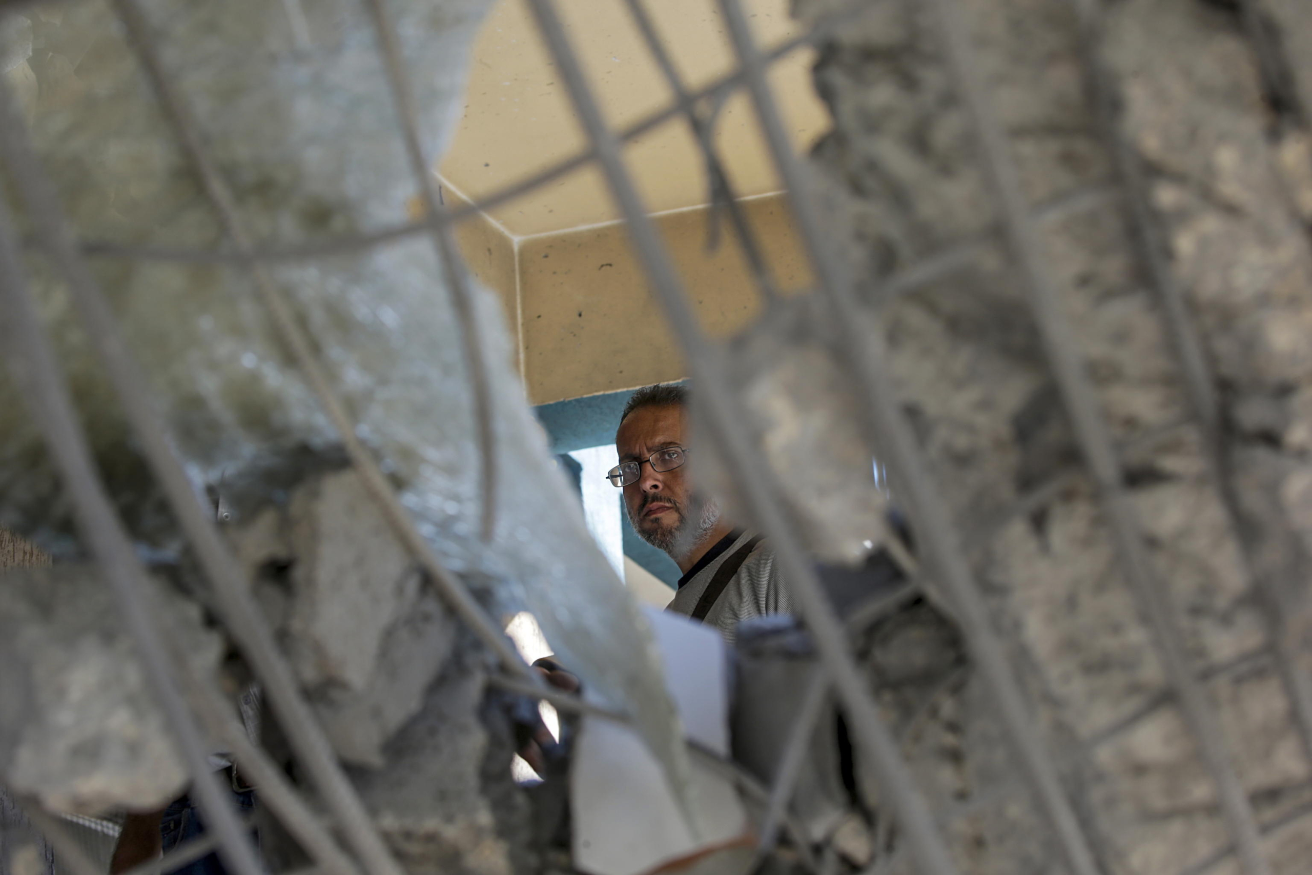 epa11478156 A Palestinian man inspects a damaged UNRWA school following an Israeli air strike in Al Nuseirat refugee camp, central Gaza Strip, 14 July 2024. At least 12 people were killed following an Israeli air strike in the camp, according to the Palestinian Ministry of Health. The Israeli military stated on 14 July, that the Israeli Air Force (IAF) struck the area of UNRWA's Abu Oraiban School School building in Nuseirat, claiming that the location served as a 'hideout and operational infrastructure' to direct and carry attacks against Israeli troops operating in the Gaza Strip. More than 38,000 Palestinians and over 1,400 Israelis have been killed, according to the Palestinian Health Ministry and the Israel Defense Forces (IDF), since Hamas militants launched an attack against Israel from the Gaza Strip on 07 October 2023, and the Israeli operations in Gaza and the West Bank which followed it.  EPA/MOHAMMED SABER