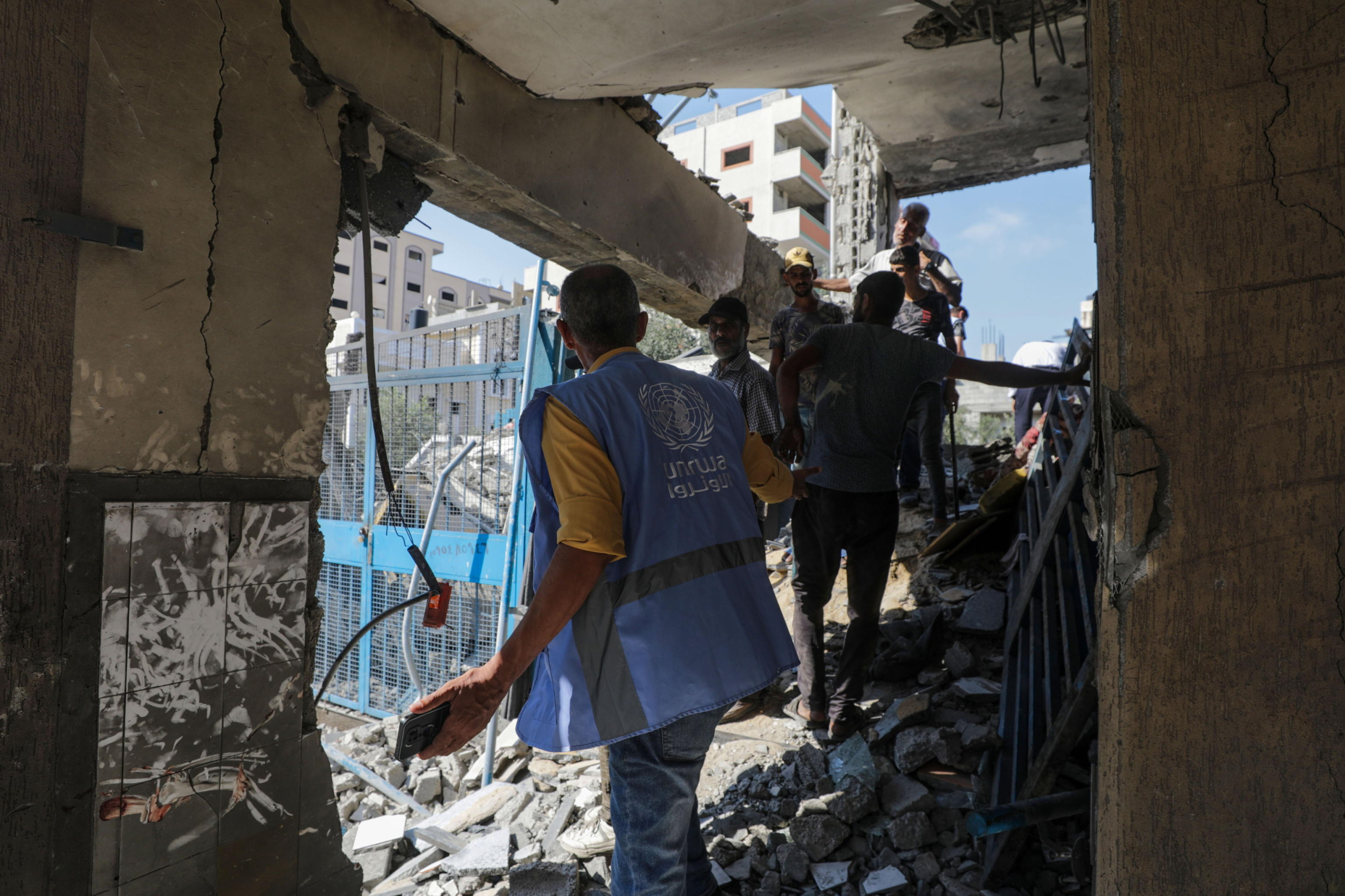 epa11478275 Palestinians inspect a damaged UNRWA school following an Israeli air strike in Al Nuseirat refugee camp, central Gaza Strip, 14 July 2024. At least 12 people were killed following an Israeli air strike in the camp, according to the Palestinian Ministry of Health. The Israeli military stated on 14 July, that the Israeli Air Force (IAF) struck the area of UNRWA's Abu Oraiban School School building in Nuseirat, claiming that the location served as a 'hideout and operational infrastructure' to direct and carry attacks against Israeli troops operating in the Gaza Strip. More than 38,000 Palestinians and over 1,400 Israelis have been killed, according to the Palestinian Health Ministry and the Israel Defense Forces (IDF), since Hamas militants launched an attack against Israel from the Gaza Strip on 07 October 2023, and the Israeli operations in Gaza and the West Bank which followed it.  EPA/MOHAMMED SABER