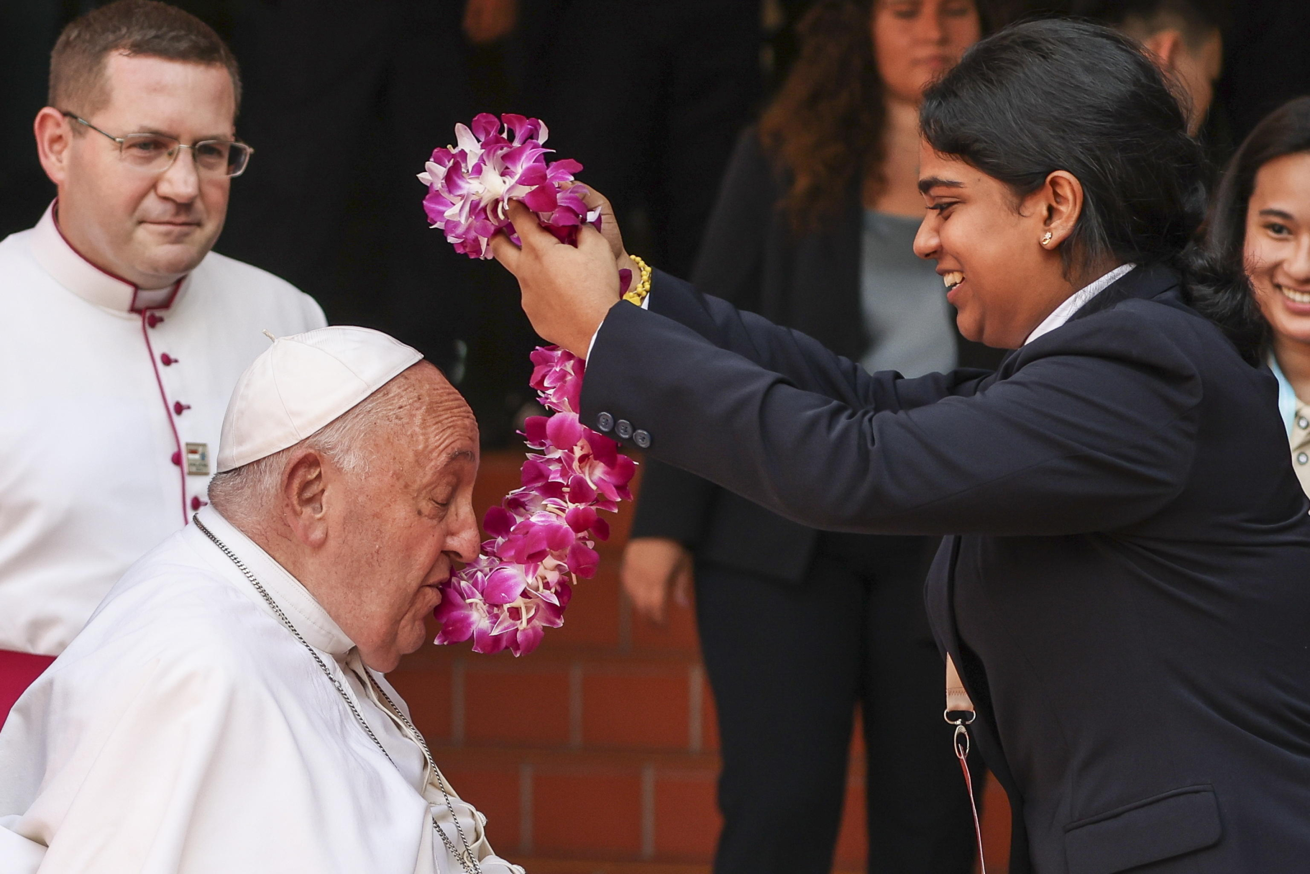 epa11601277 Pope Francis (L) is greeted by a student  upon his arrival to an interreligious meeting with young people at the Catholic Junior College in Singapore, 13 September 2024. Pope Francis is visiting Singapore from 11 to 13 September, marking the final stop of his apostolic journey through the Asia-Pacific region, which also included Indonesia, Papua New Guinea, and East Timor.  EPA/HOW HWEE YOUNG