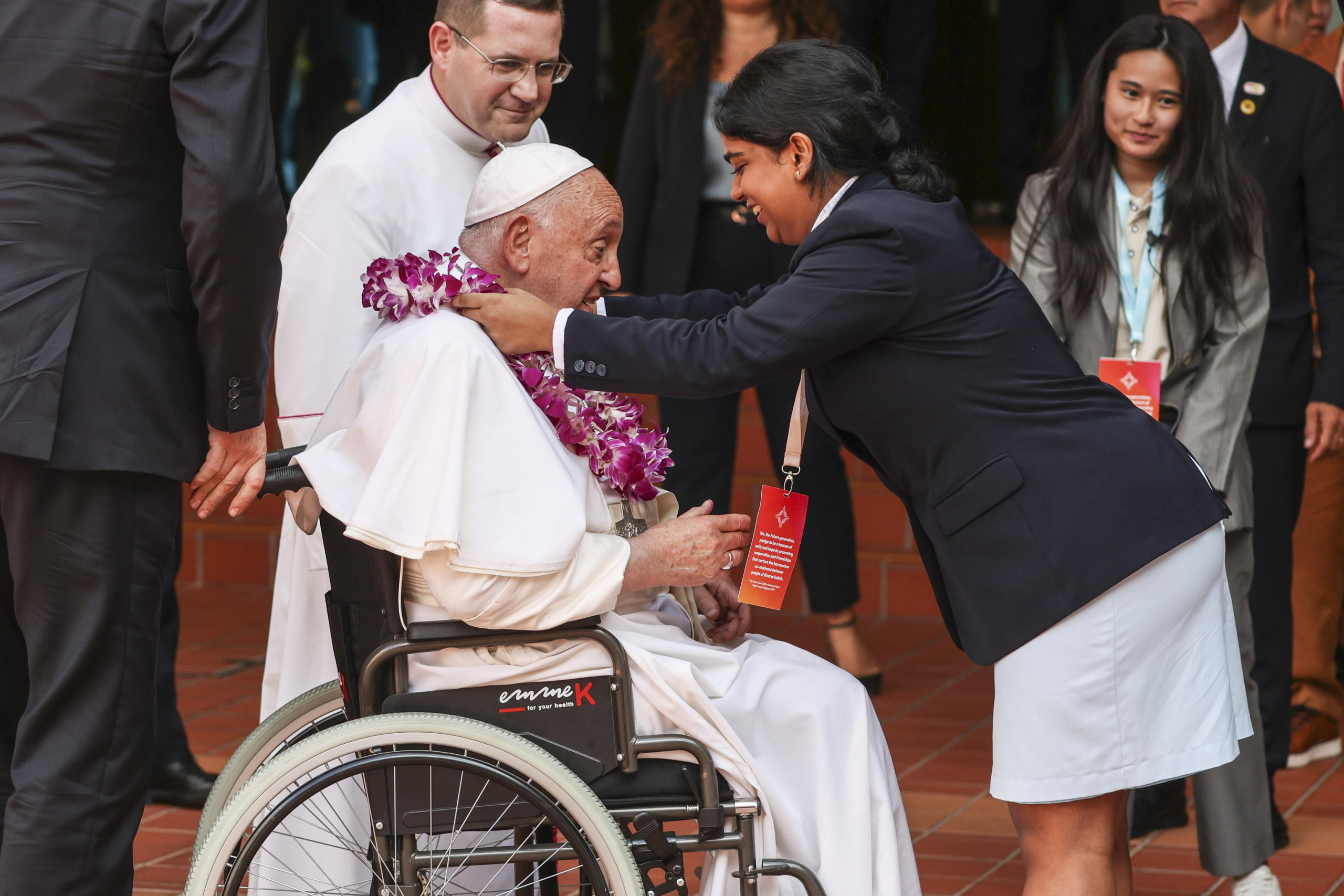 epa11601280 Pope Francis (L) is greeted by a student  upon his arrival to an interreligious meeting with young people at the Catholic Junior College in Singapore, 13 September 2024. Pope Francis is visiting Singapore from 11 to 13 September, marking the final stop of his apostolic journey through the Asia-Pacific region, which also included Indonesia, Papua New Guinea, and East Timor.  EPA/HOW HWEE YOUNG