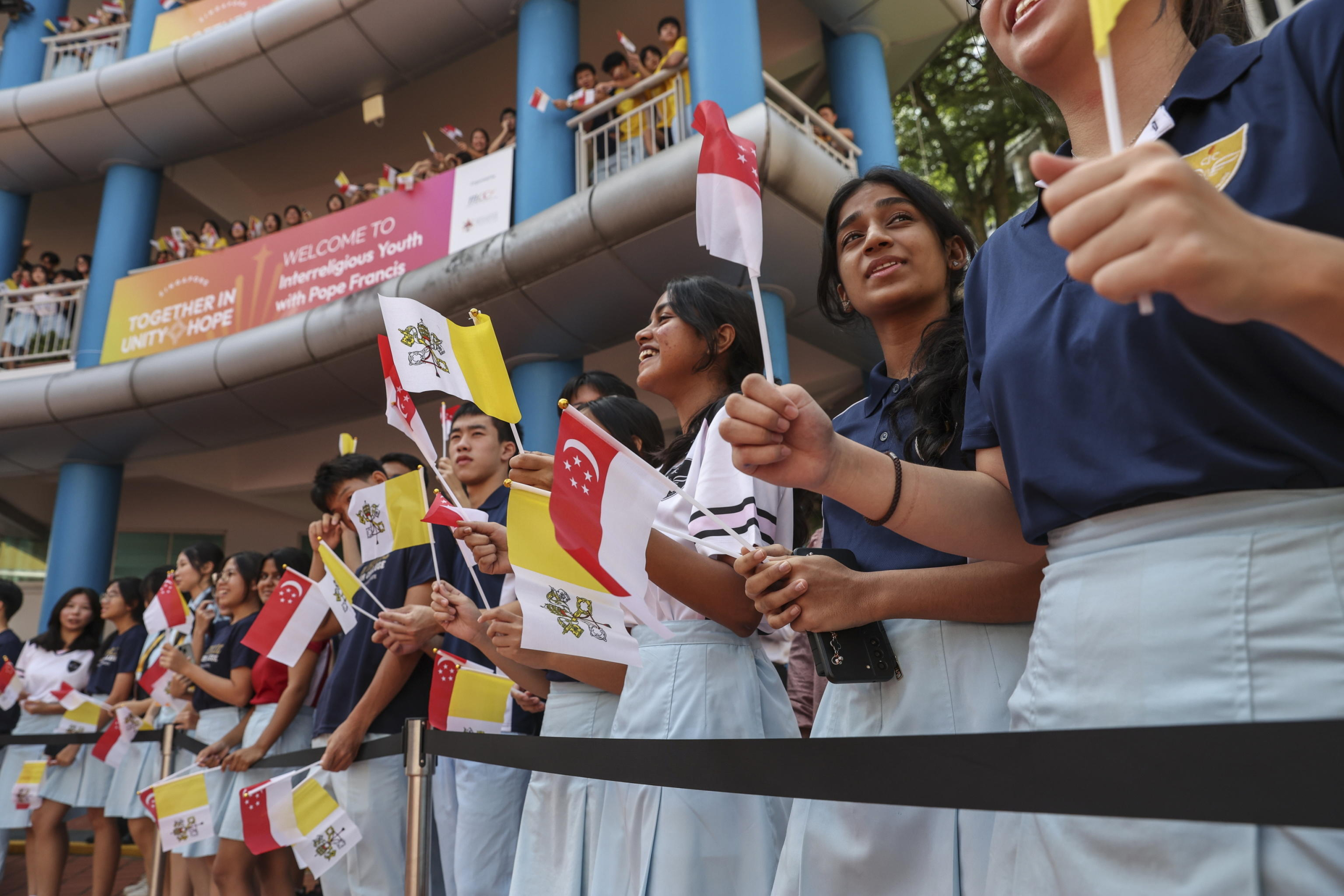 epa11601300 Students prepare for the arrival of Pope Francis (Not Pictured) to an interreligious meeting with young people at the Catholic Junior College in Singapore, 13 September 2024. Pope Francis is visiting Singapore from 11 to 13 September, marking the final stop of his apostolic journey through the Asia-Pacific region, which also included Indonesia, Papua New Guinea, and East Timor.  EPA/HOW HWEE YOUNG