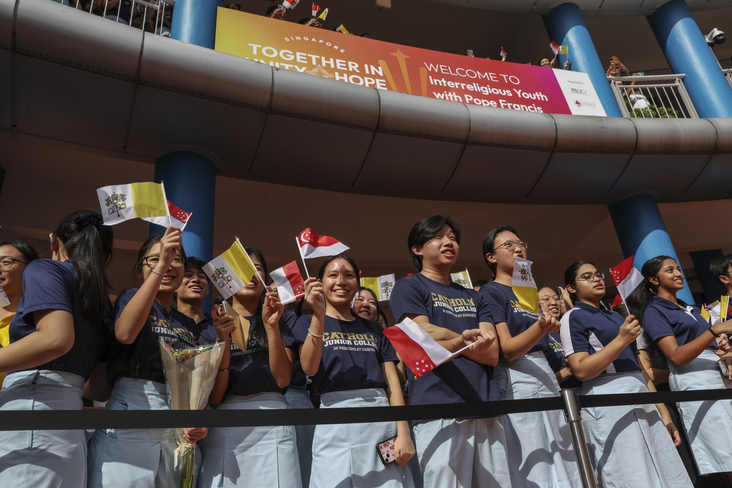 epa11601322 Students prepare for the arrival of Pope Francis (Not Pictured) for an interreligious meeting with young people at the Catholic Junior College in Singapore, 13 September 2024. Pope Francis is visiting Singapore from 11 to 13 September, marking the final stop of his apostolic journey through the Asia-Pacific region, which also included Indonesia, Papua New Guinea, and East Timor.  EPA/HOW HWEE YOUNG