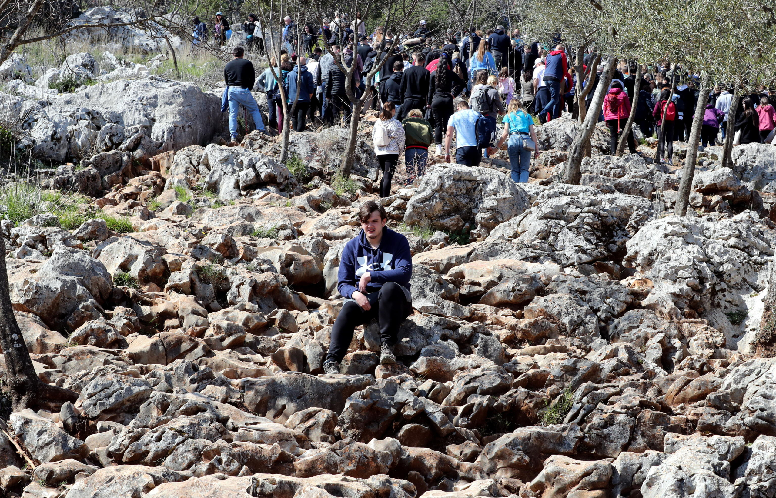 epa10563445 Pilgrims climb Krizevac hilll during a Good Friday procession to the place of the  supernatural appearance by the Virgin Mary, the mother of Jesus, in the village of Medugorje, southern Bosnia and Herzegovina, 07 April 2023. Thousands of pilgrims from all over the world gathered in Medjugorje where the Virgin Mary is believed to have appeared to local shepherd children on 24 June 1981 in the hills around the village. It is believed that more than 30 million people have visited the world-famous village since the first Virgin Mary appearance in Medjugorje, which the church has not yet recognized.  EPA/FEHIM DEMIR