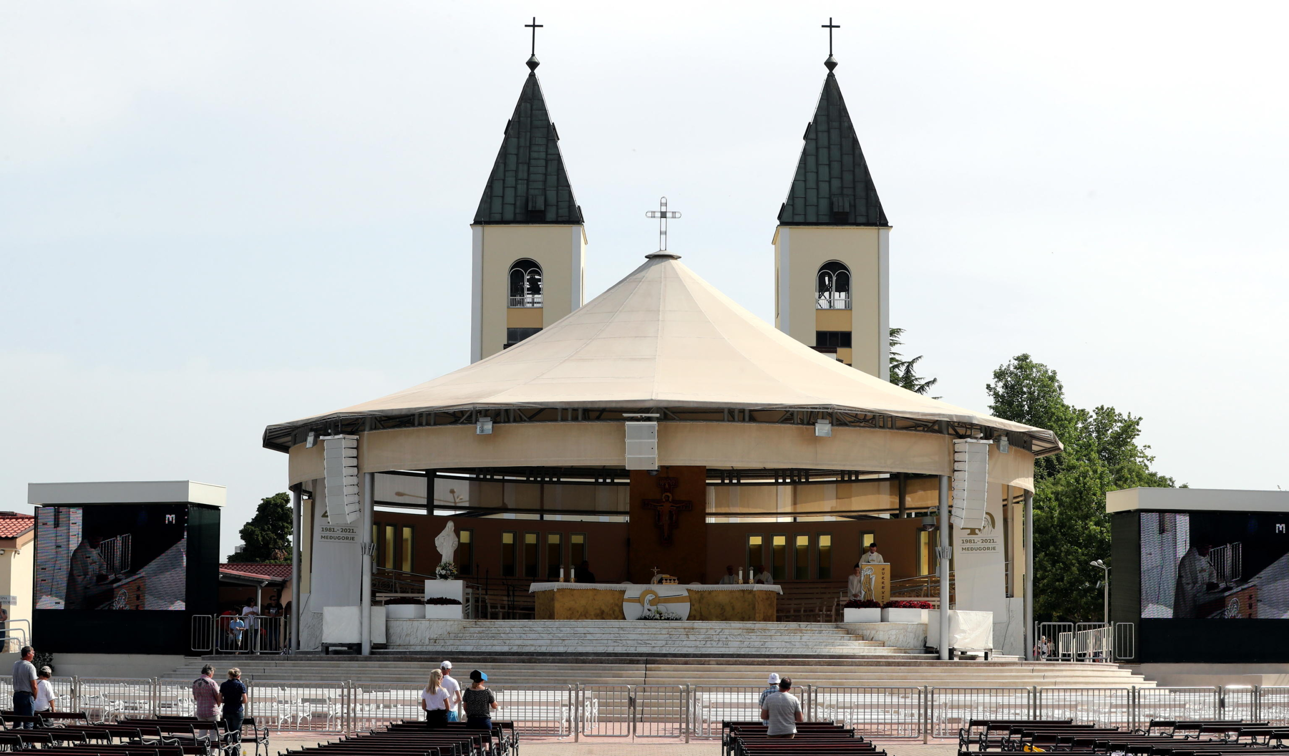 epa09300611 Pilgrims pray in front of the church in the village of Medjugorje, Bosnia and Herzegovina, 25 June 2021. Pilgrims gathered in Medjugorje to mark the 40th anniversary of the alleged appearance of the Virgin Mary to local shepherds in the hills surrounding the village. More than 30 million people are believed to have visited the world-famous village since the saint's first appearance. The Catholic Church has not yet recognized the miracle of Holy Mary's appearance to the Medjugorje shepherds on 24 June 1981.  EPA/FEHIM DEMIR