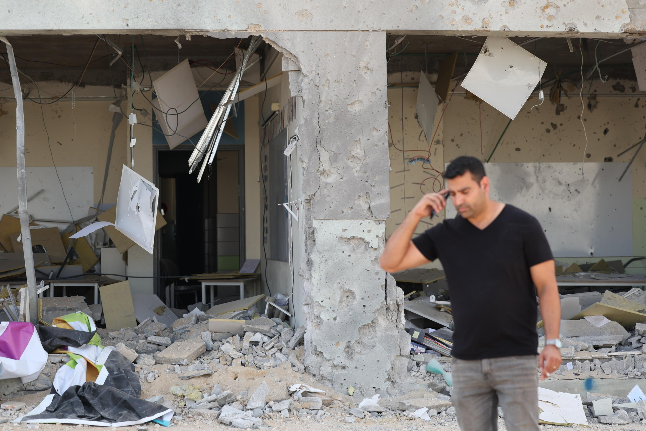 epa11637140 A municipality worker inspects a school damaged by ballistic missiles fired from Iran, in Gedera, Israel, 02 October 2024. According to the Israeli military, Iran launched over 180 ballistic missiles towards Israel in the evening of 01 October, with alert sirens sounding across the country.  EPA/ABIR SULTAN