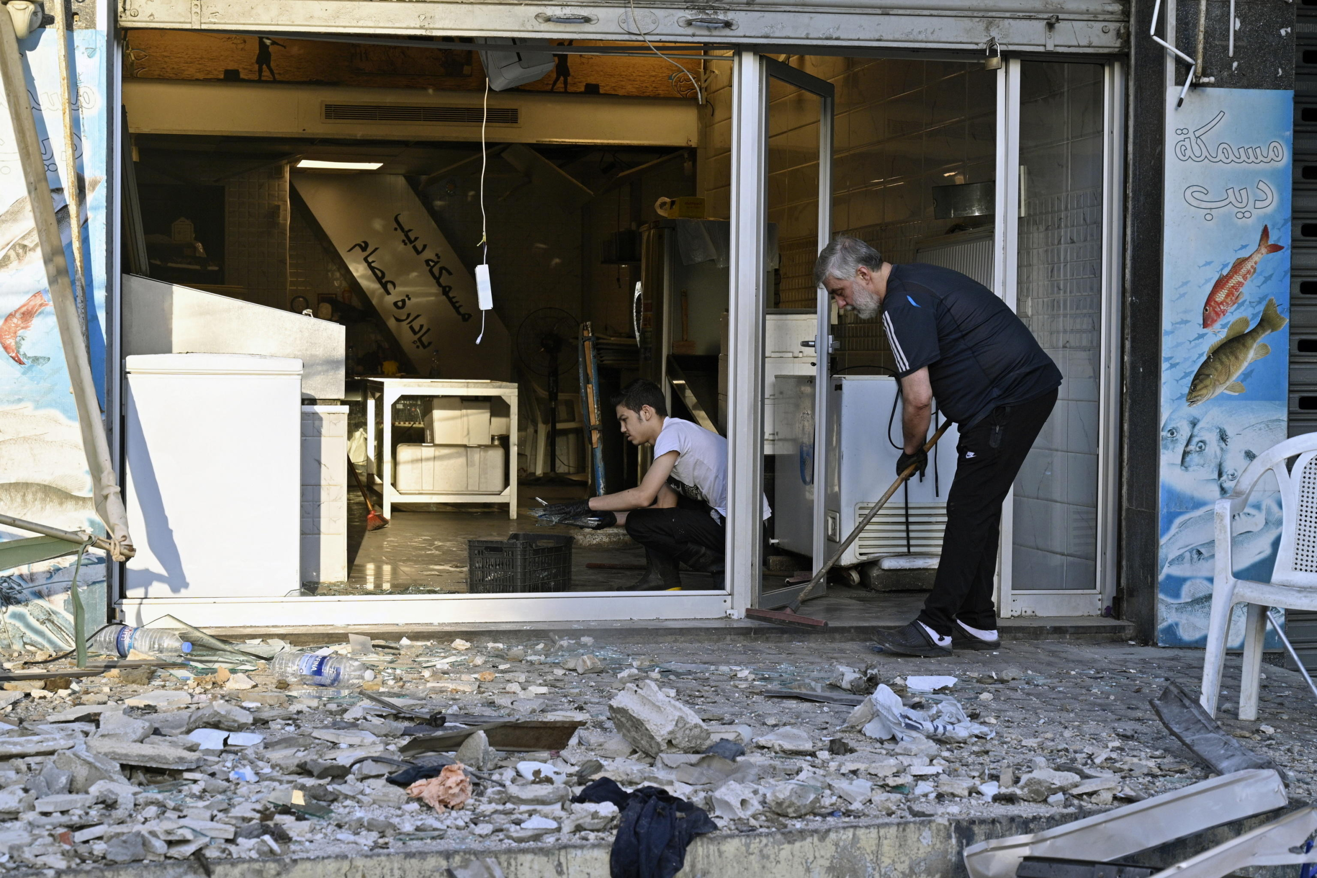 epa11639146 People clean a shop from debris following an Israeli airstrike in Beirut's Bachoura neighborhood, Lebanon, 03 October 2024. Lebanese officials reported that an Israeli airstrike on a building in central Beirut resulted in at least five deaths and eight injuries.  EPA/WAEL HAMZEH