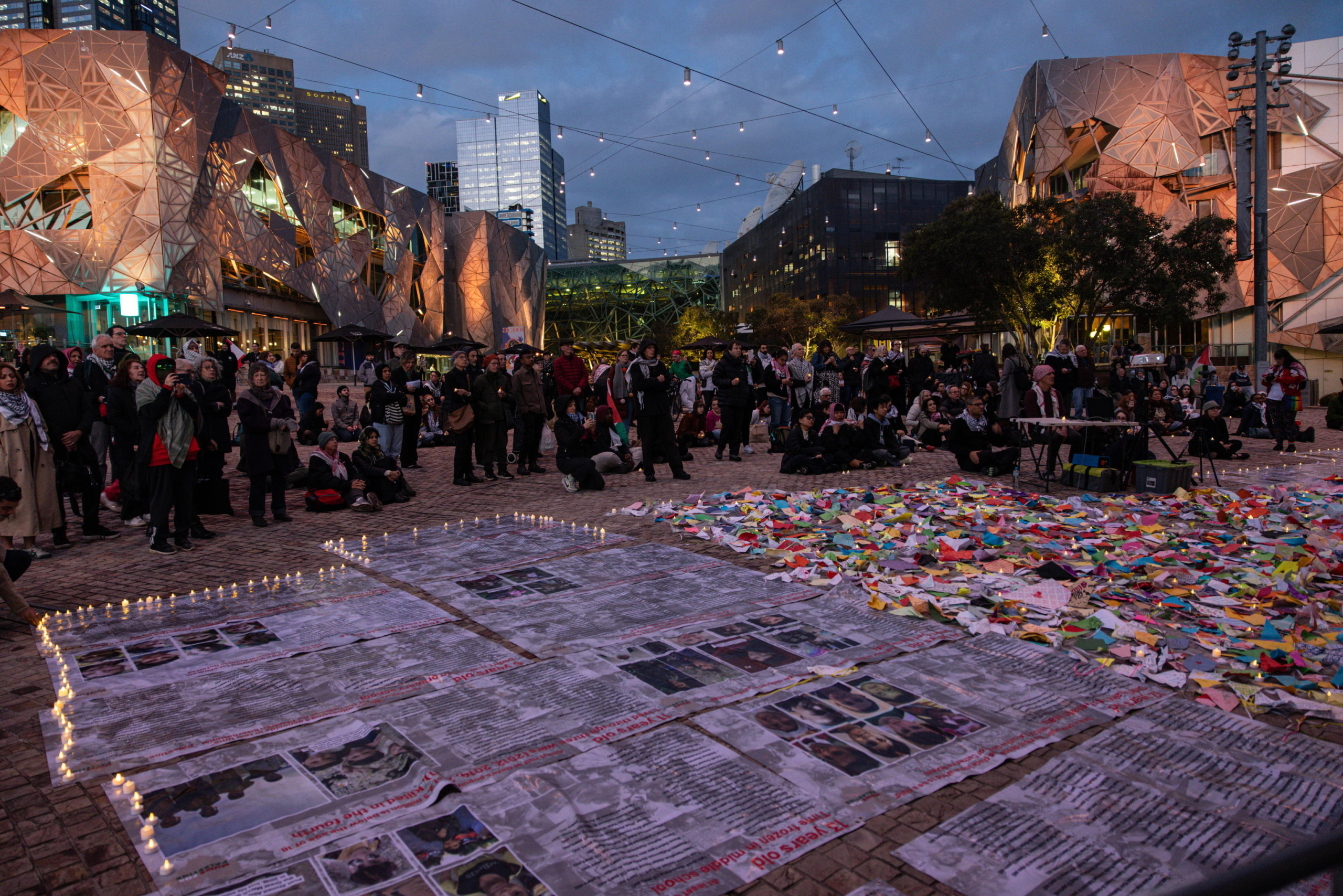 epa11654330 Community members gather for a Free Palestine Melbourne vigil to remember victims of the Gaza attacks at Federation Square in Melbourne, Australia, 11 October 2024. A Free Palestine Melbourne vigil is taking place at Federation Square, where community members are gathering to remember victims of Israeli attacks in Gaza.  EPA/DIEGO FEDELE AUSTRALIA AND NEW ZEALAND OUT