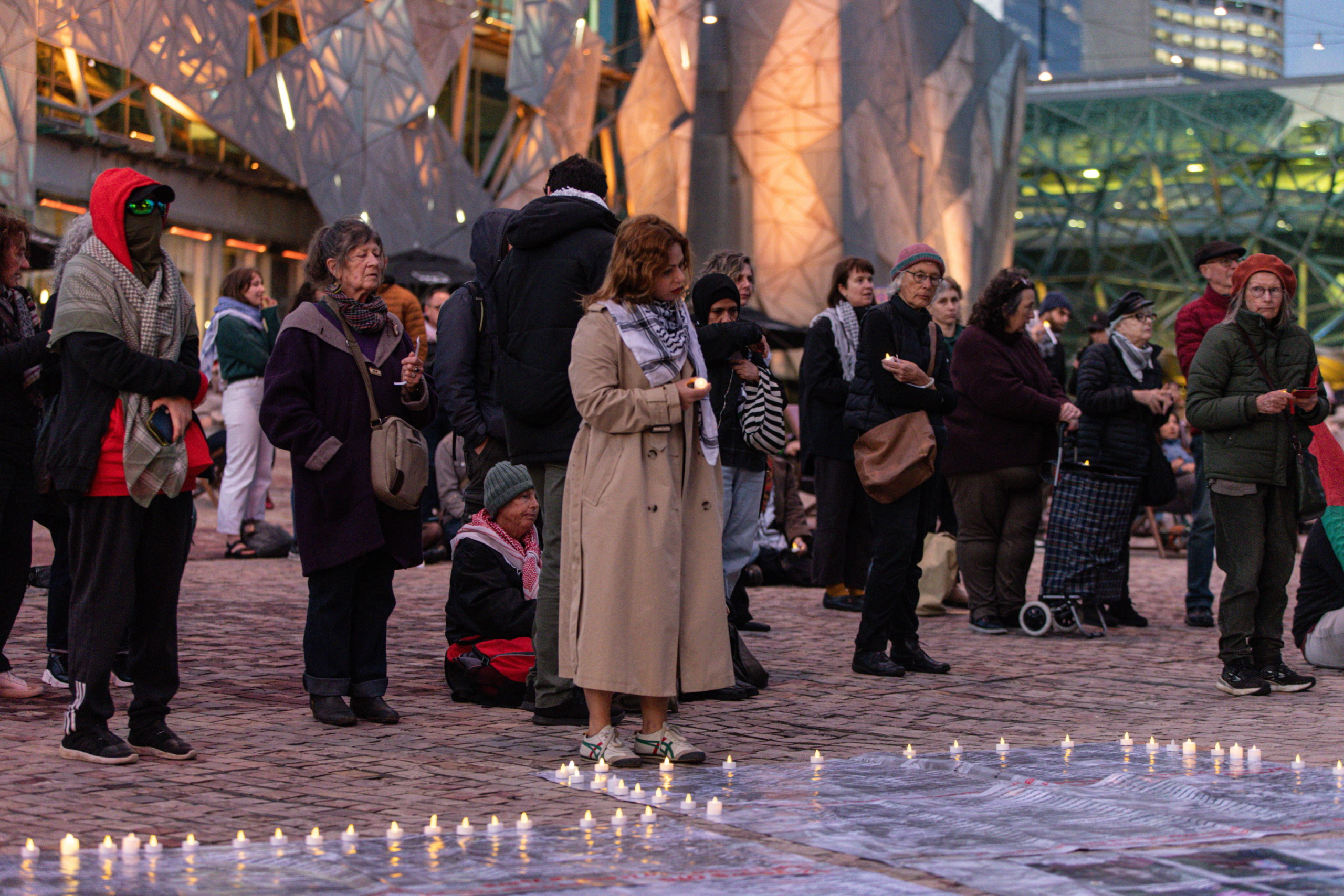 epa11654338 Community members gather for a Free Palestine Melbourne vigil to remember victims of the Gaza attacks at Federation Square in Melbourne, Australia, 11 October 2024. A Free Palestine Melbourne vigil is taking place at Federation Square, where community members are gathering to remember victims of Israeli attacks in Gaza.  EPA/DIEGO FEDELE AUSTRALIA AND NEW ZEALAND OUT