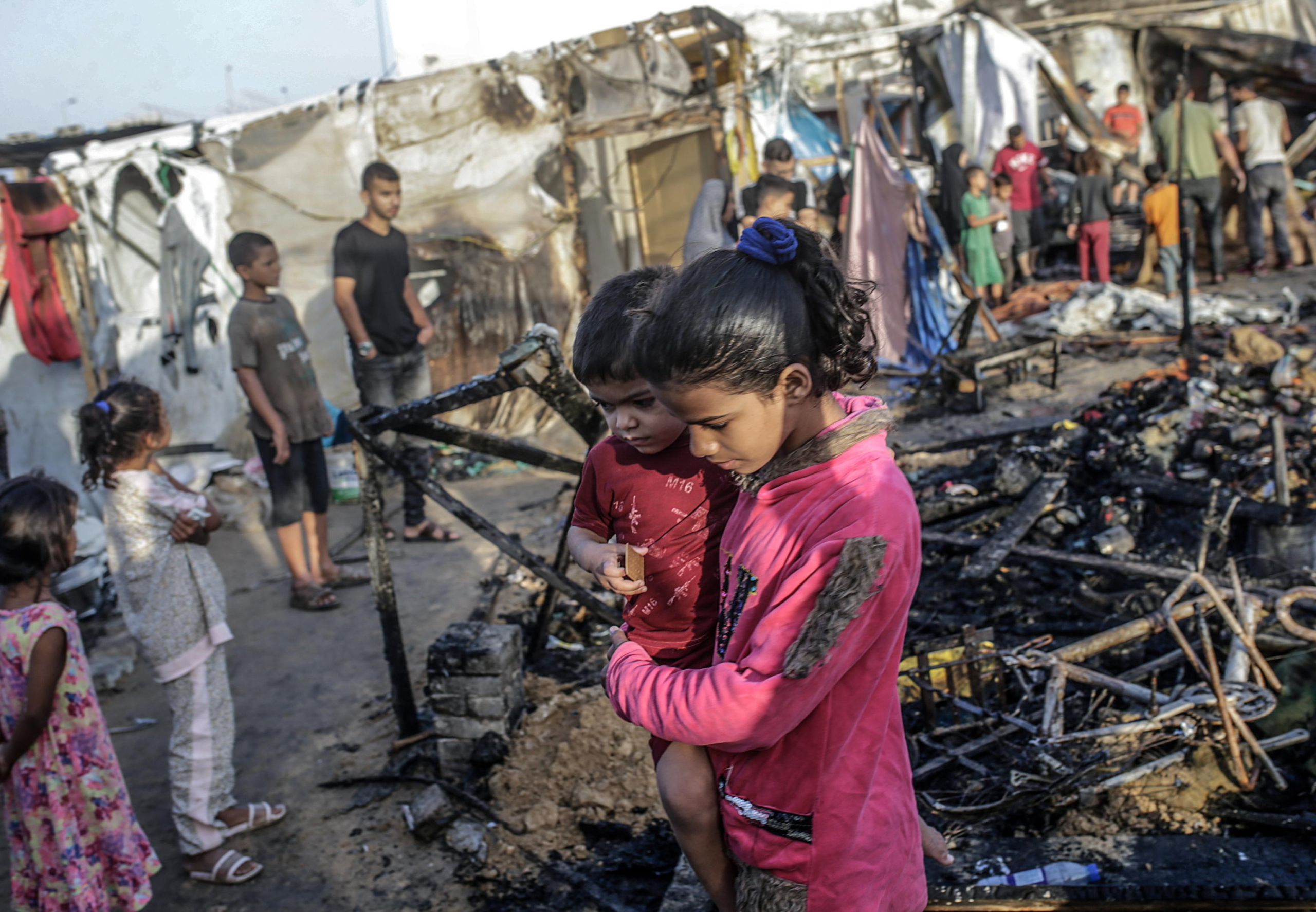 epa11657929 Palestinians inspect destroyed makeshift tents at a camp for internally displaced people on the premises of al-Aqsa Hospital, after the area was hit by an Israeli air strike, in Deir al Balah, central Gaza Strip, 14 October 2024. According to the Palestinian Ministry of Health, four people were killed as a result of the strike on al-Asqa hospital, and several dozens were wounded. More than 42,200 Palestinians and over 1,400 Israelis have been killed, according to the Palestinian Health Ministry and the Israel Defense Forces (IDF), since Hamas militants launched an attack against Israel from the Gaza Strip on 07 October 2023, and the Israeli operations in Gaza and the West Bank which followed it.  EPA/MOHAMMED SABER