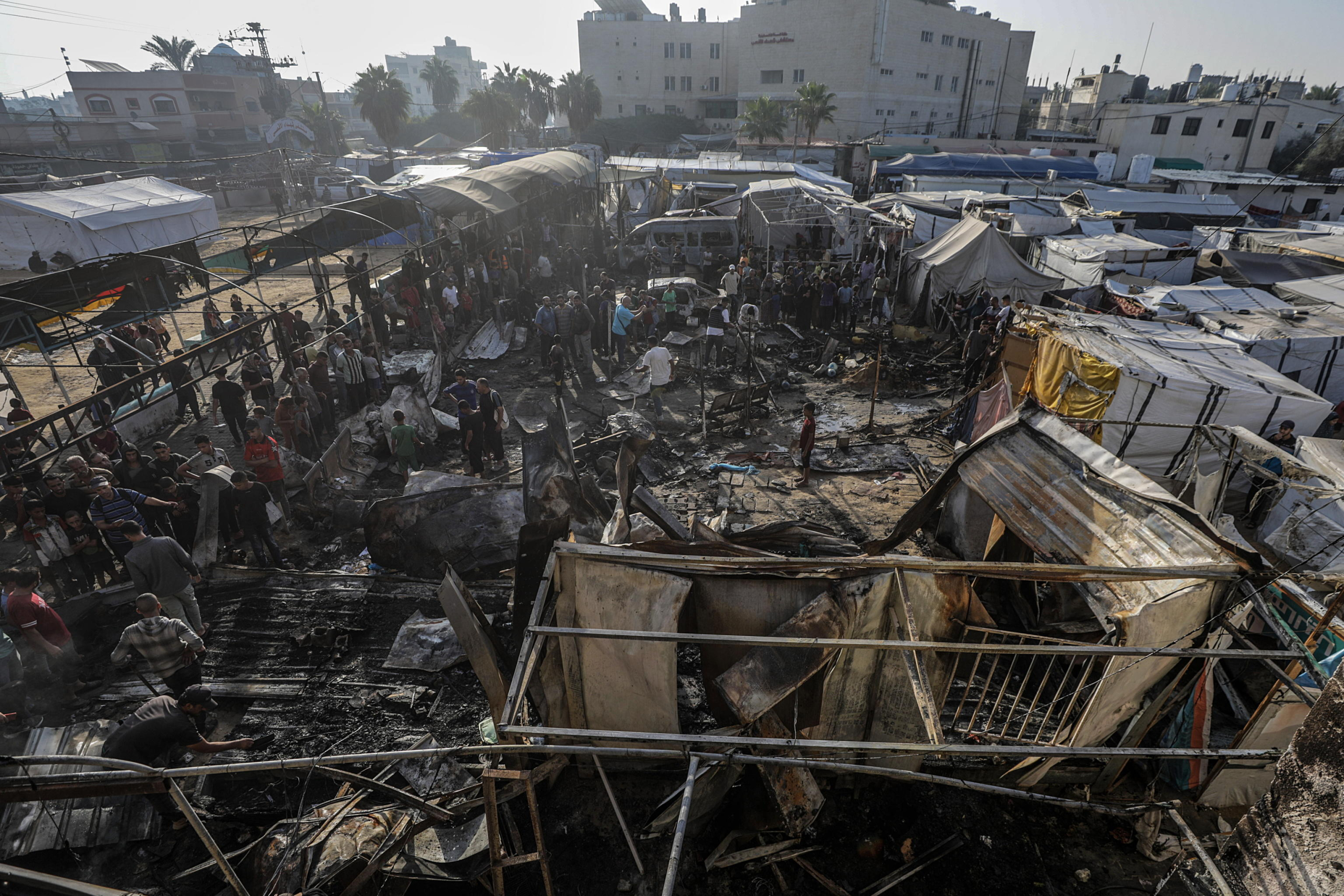 epa11657922 Palestinians inspect destroyed makeshift tents at a camp for internally displaced people on the premises of al-Aqsa Hospital, after the area was hit by an Israeli air strike, in Deir al Balah, central Gaza Strip, 14 October 2024. According to the Palestinian Ministry of Health, four people were killed as a result of the strike on al-Asqa hospital, and several dozens were wounded. More than 42,200 Palestinians and over 1,400 Israelis have been killed, according to the Palestinian Health Ministry and the Israel Defense Forces (IDF), since Hamas militants launched an attack against Israel from the Gaza Strip on 07 October 2023, and the Israeli operations in Gaza and the West Bank which followed it.  EPA/MOHAMMED SABER