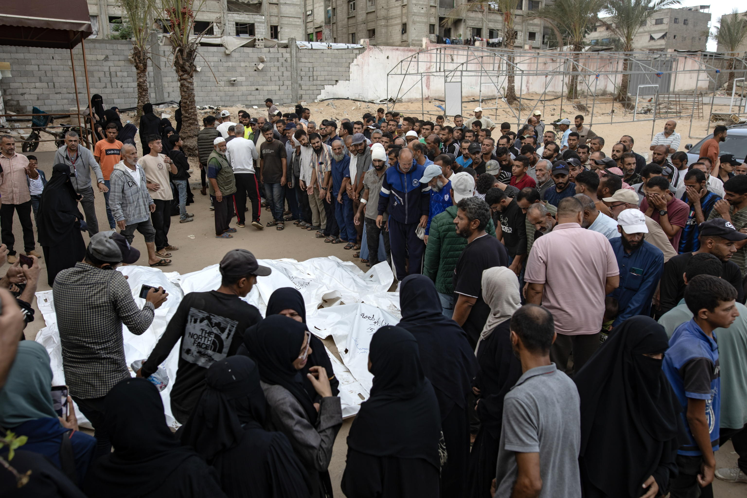 epa11659965 Palestinians, including victims' relatives, gather next to the bodies of members of the Abu Taima family, killed in an Israeli air strike, at the Khan Younis refugee camp, southern Gaza Strip, 15 October 2024. According to Nasser Hospital, at least 10 members of an extended family were killed in an Israeli airstrike on their home in Bani Suhaila, east of Khan Younis early on 15 October. More than 42,200 Palestinians and over 1,400 Israelis have been killed, according to the Palestinian Health Ministry and the Israeli Army, Tsahal, since Hamas militants launched an attack against Israel from the Gaza Strip on 07 October 2023, and the Israeli operations in Gaza and the West Bank which followed it.  EPA/HAITHAM IMAD