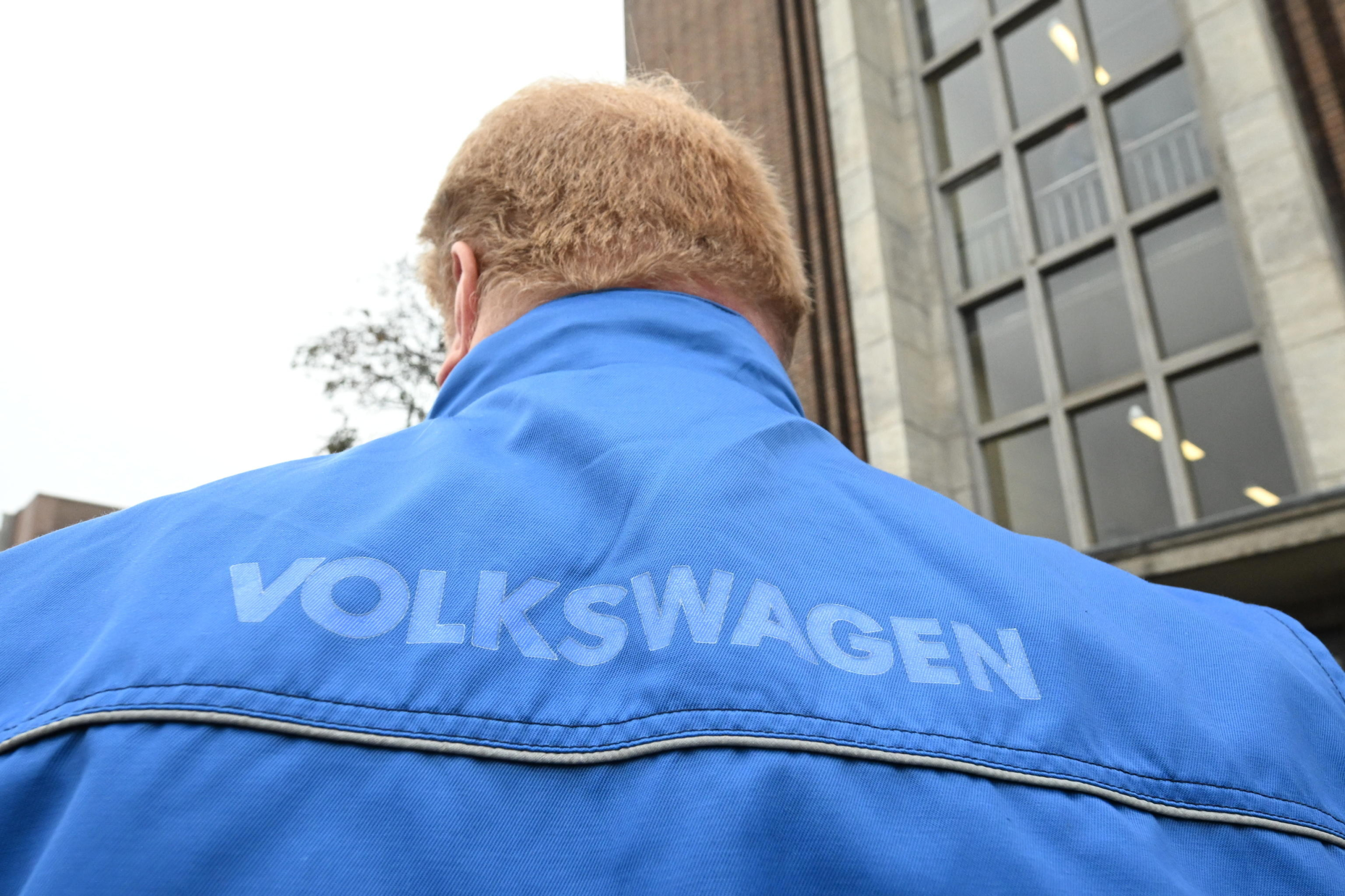 epa11688692 An employee participates in an informational event organized by the General Works Council of Volkswagen AG at the company's main plant in Wolfsburg, Germany, 28 October 204. The event will address topics such as wage reductions, possible plant shutdowns, and workforce layoffs.  EPA/JULIAN STRATENSCHULT / POOL