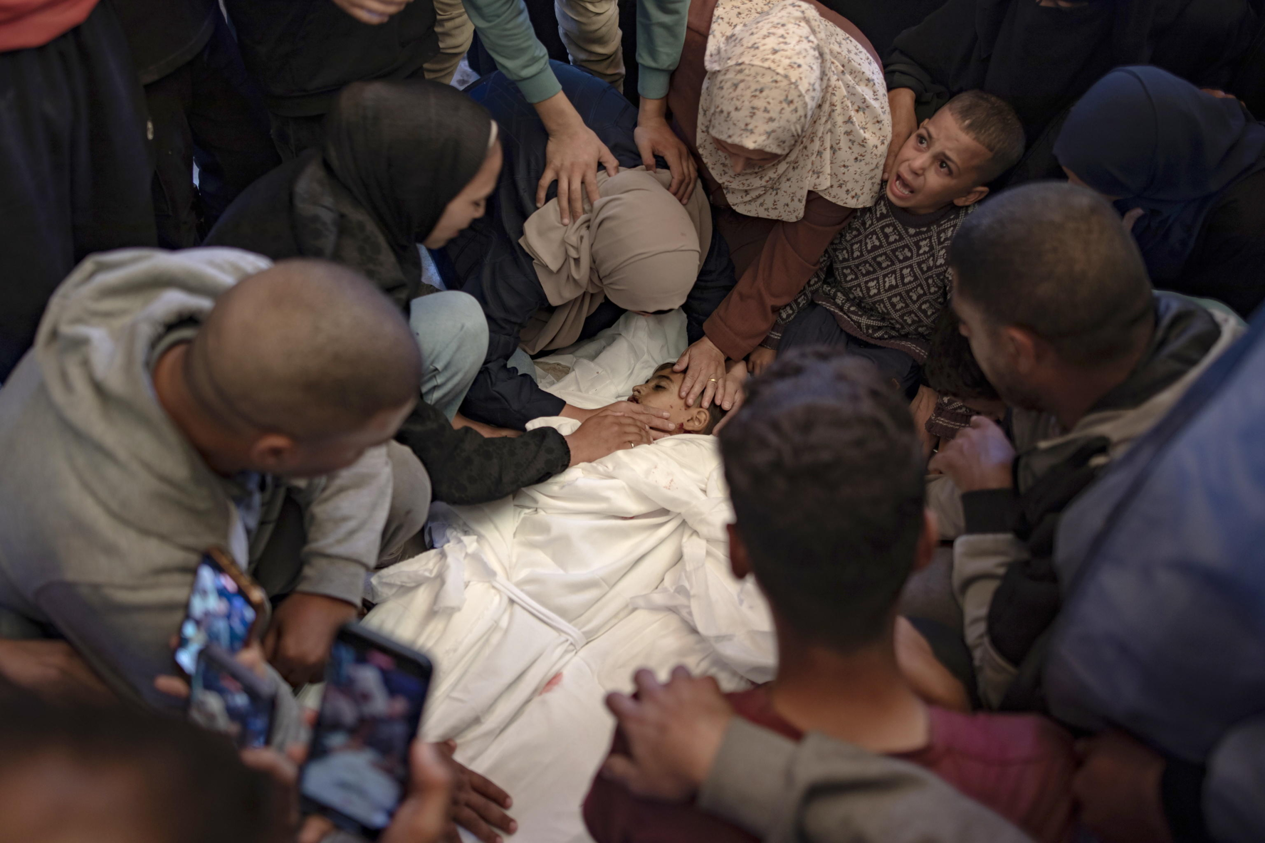 epa11699133 Family members mourn next to the bodies of their loved ones at Nasser Hospital following an Israeli airstrike that claimed the lives of at least eight people in Khan Yunis, southern Gaza Strip, 03 November 2024. More than 43,000 Palestinians and over 1,400 Israelis have been killed, according to the Palestinian Health Ministry and the Israel Defense Forces (IDF), since Hamas militants launched an attack against Israel from the Gaza Strip on 07 October 2023, and the Israeli operations in Gaza and the West Bank which followed it.  EPA/HAITHAM IMAD ATTENTION EDITORS: GRAPHIC CONTENT