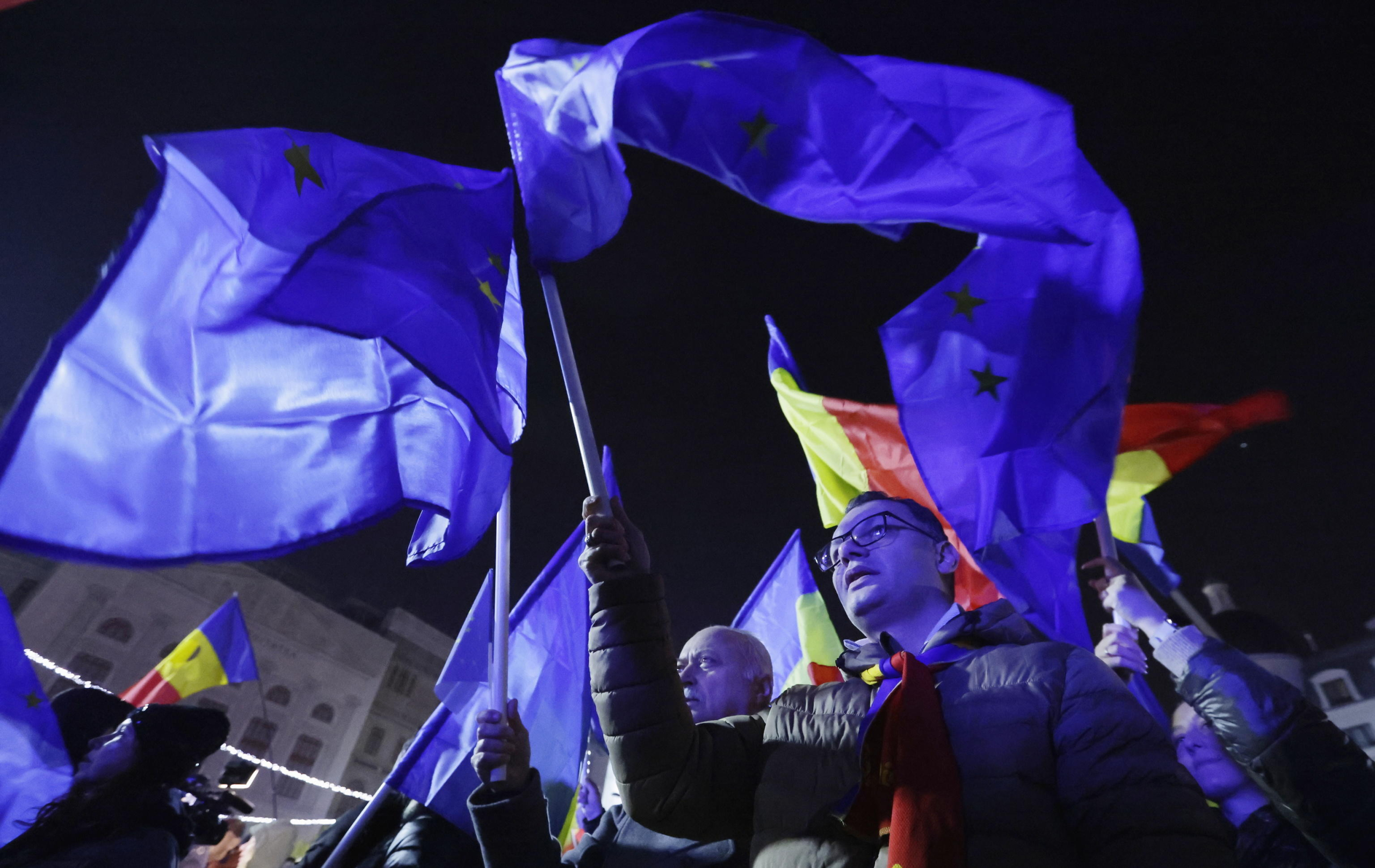 epaselect epa11759167 People shout slogans and wave Romanian and EU flags during a Pro-Europe rally ahead of the presidential runoff at the University Plaza in downtown Bucharest, Romania, 05 December 2024. Thousands of people and civil rights activists gathered to support European Union core values during a rally Romania Hopes! Every vote counts!', organized by Geeks for Romania NGO and endorsed by the Save Romania Union Party (USR). Romania is set for the second round of presidential election after its top court certified shock first-round result, confirming the lead of independent ultra-nationalist candidate Calin Georgescu, who will face USR liberal leader Elena Lasconi in the second round on 08 December.  EPA/ROBERT GHEMENT