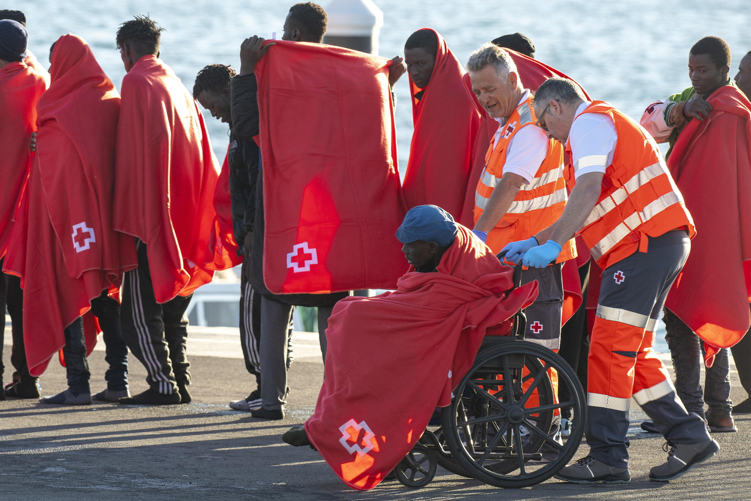 epa11783525 Several migrants are taken care of by the Red Cross upon their arrival at the port in the town of Arrecife, Lanzarote island, Canary Islands, southwestern Spain, 18 December 2024. Spanish authorities rescued 57 migrants, including five women, 83 km off Lanzarote Island.  EPA/Adriel Perdomo