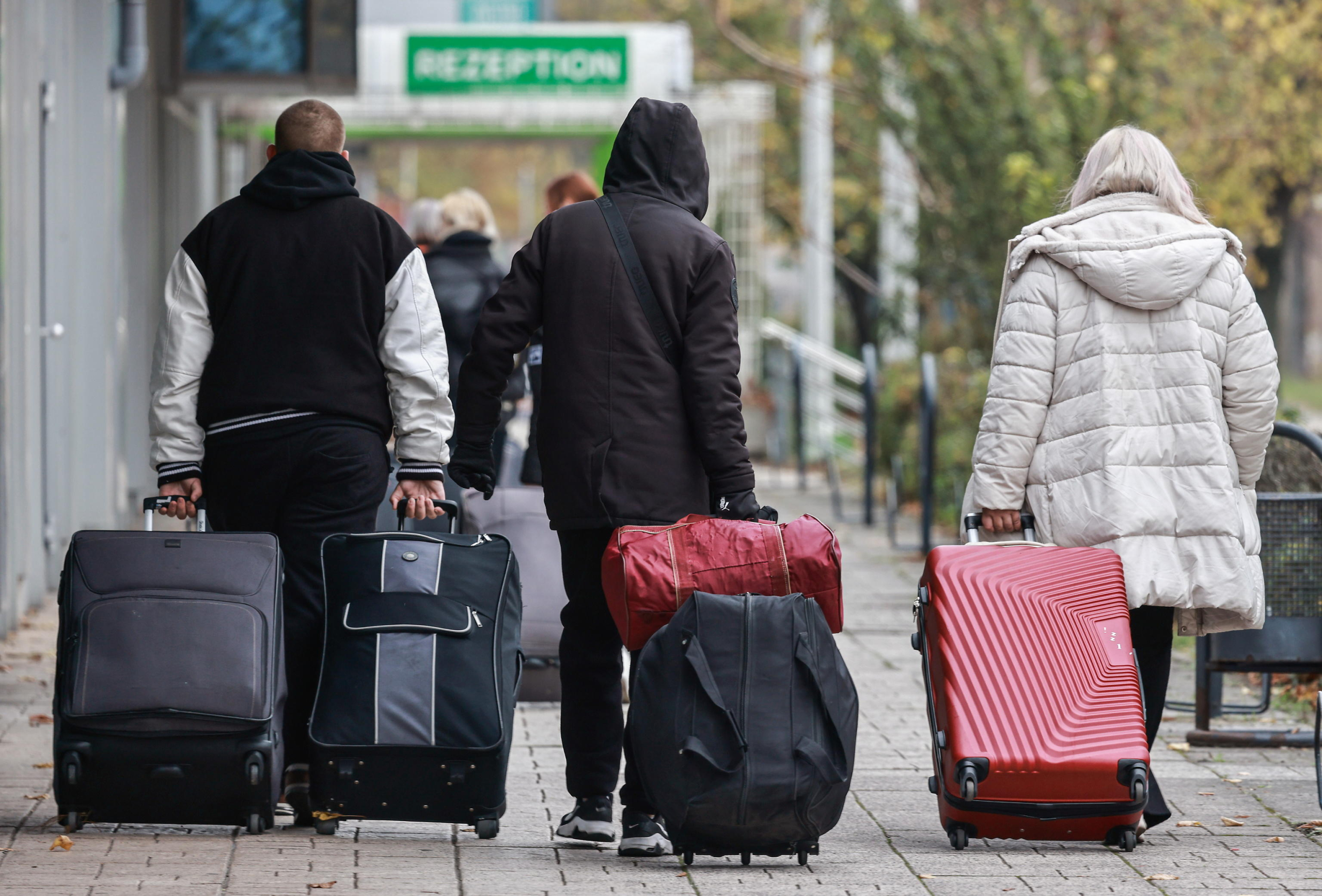 epa11714742 Migrants walk in front of the former Grand City Hotel Berlin at street Landsberger in Berlin, Germany, 11 November 2024. Refugees from the large accommodation center in Tegel moved into the Grand City Hotel. Several refugees are to be accommodated in the new center until the beginning of December. The refugees are asylum seekers from various countries as well as war refugees from Ukraine.  EPA/HANNIBAL HANSCHKE